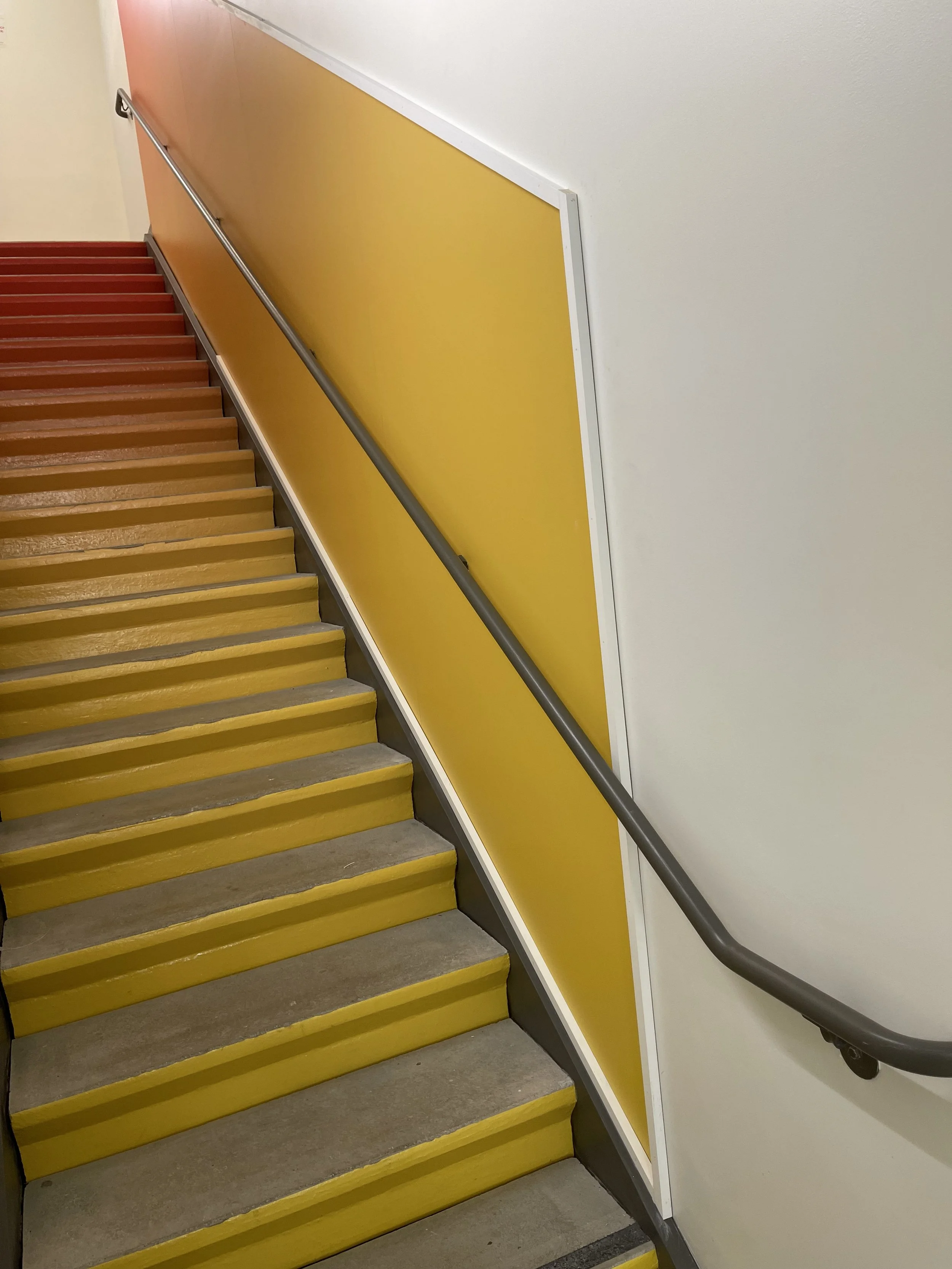 Perspective view from the base of the stair showing finished environmental wall graphics at Google Santa Cruz.