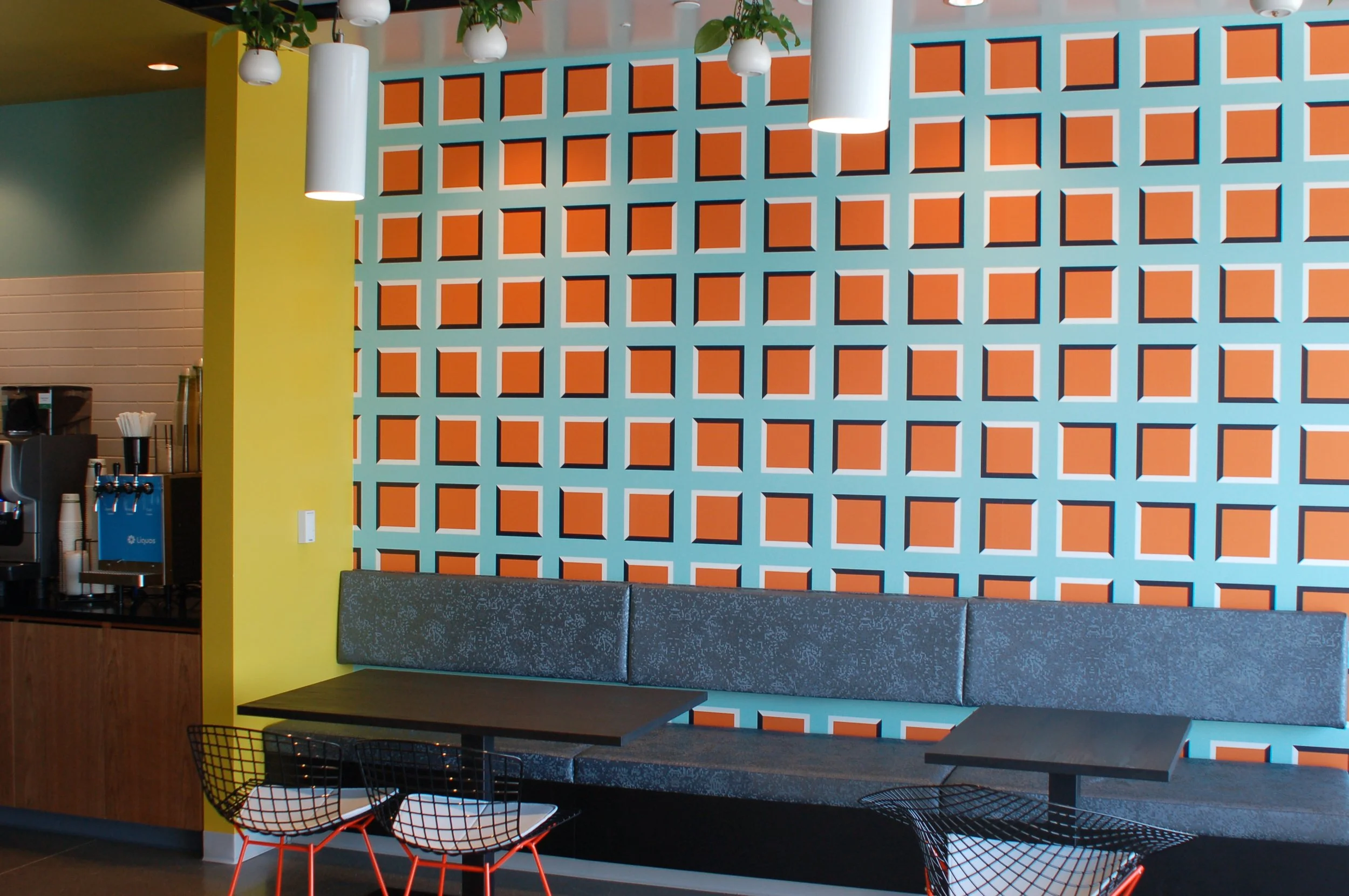 Decorative architectural screen and custom environmental graphics used to create visual interest in a commercial office.