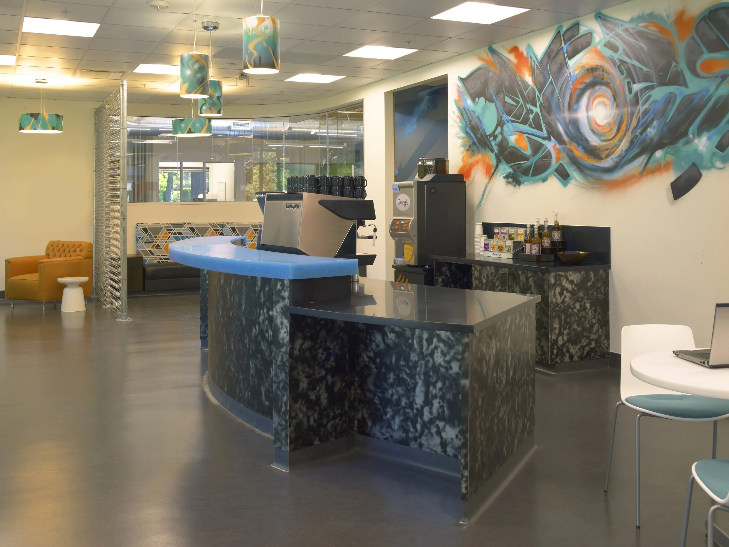 Corporate lobby featuring custom digital print wall graphics and environmental branding throughout the workspace.