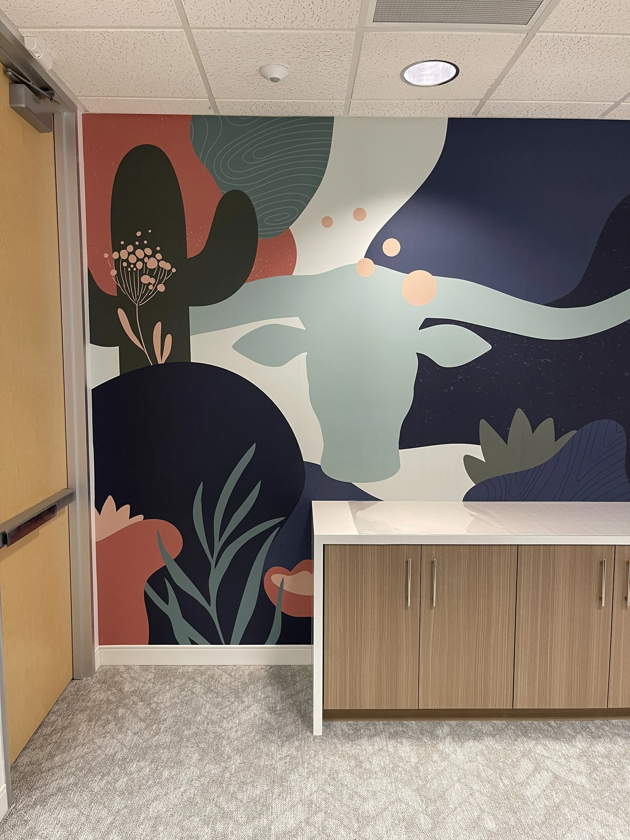 eBay Austin Longhorn Conference Room wallcovering detail showing custom large-format environmental graphics installed behind reception counter.
