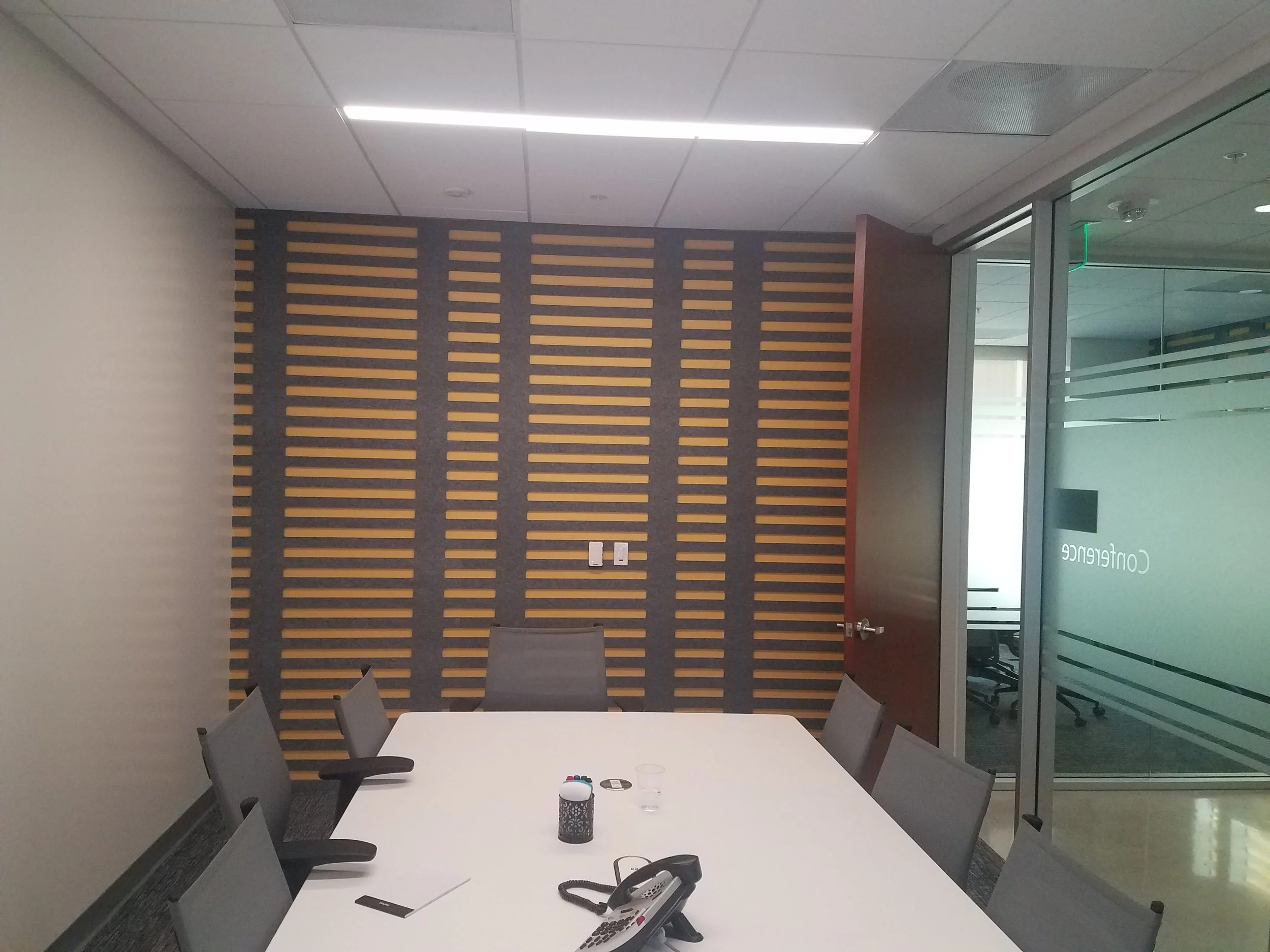 Wood slat acoustic feature wall improving sound quality and adding warmth to meeting space