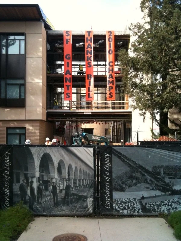 Large-scale exterior banner signage installed to promote brand presence on commercial building facade