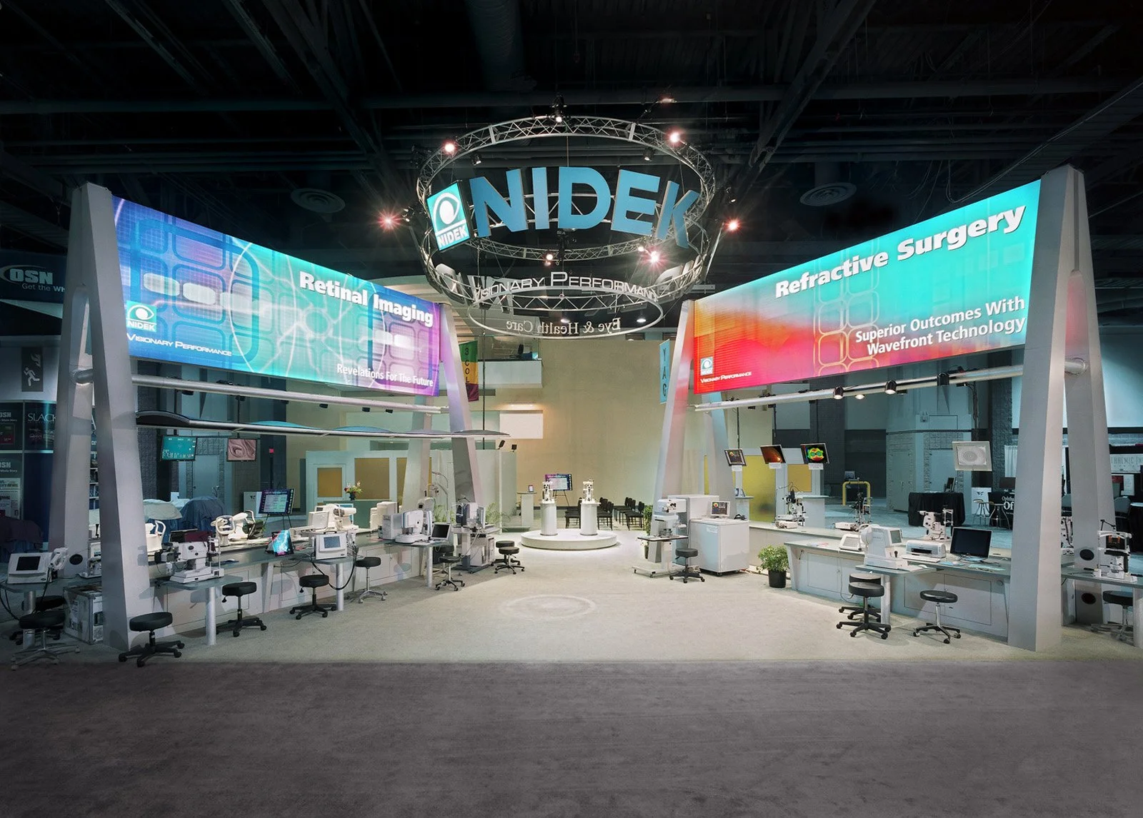 Large-scale custom trade show booth with overhead branding and immersive exhibit environment