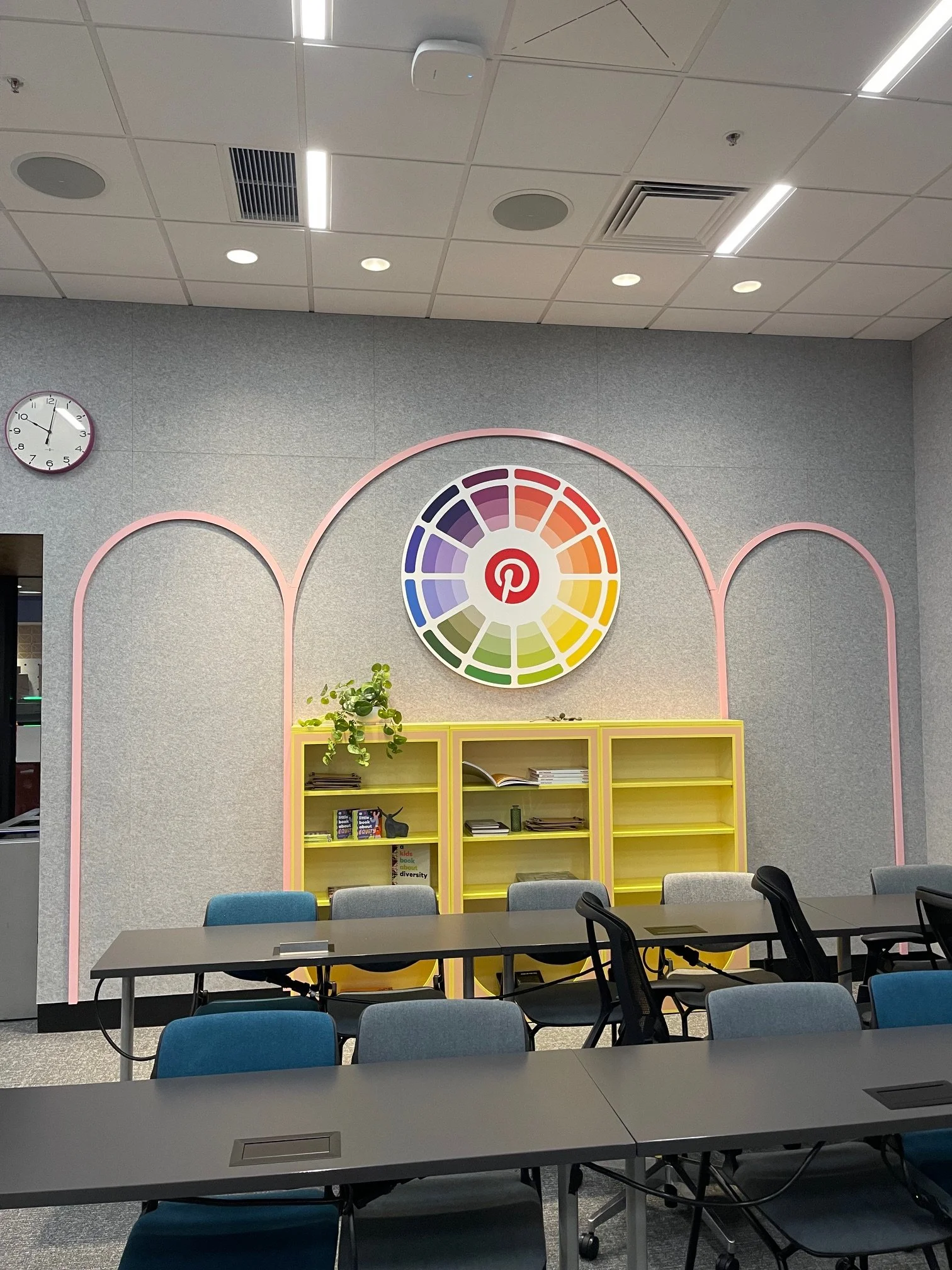 Pinterest breakroom in San Francisco featuring installed color wheel graphic, arched wall accents, and custom storage cabinets as part of environmental branding by JP Digital.