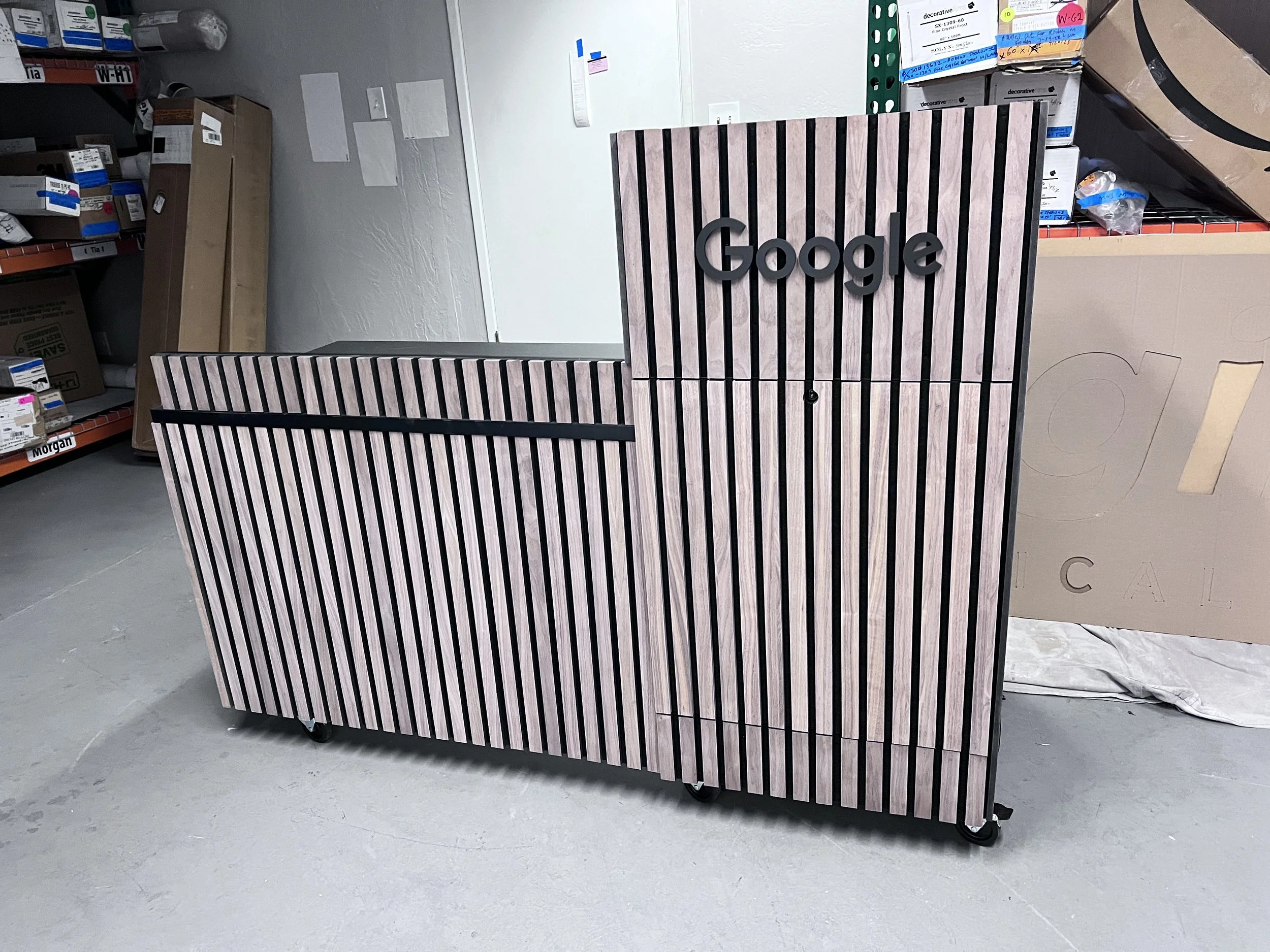 Dimensional curved architectural installation designed to create visual movement and define space within commercial interior.