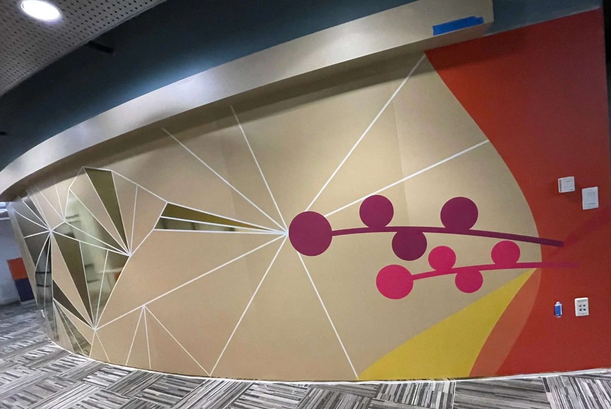 Curved abstract graphic wallcovering with geometric color blocks installed in Amazon SJC3 office corridor, fabricated and installed by JP Digital in Cupertino, California.