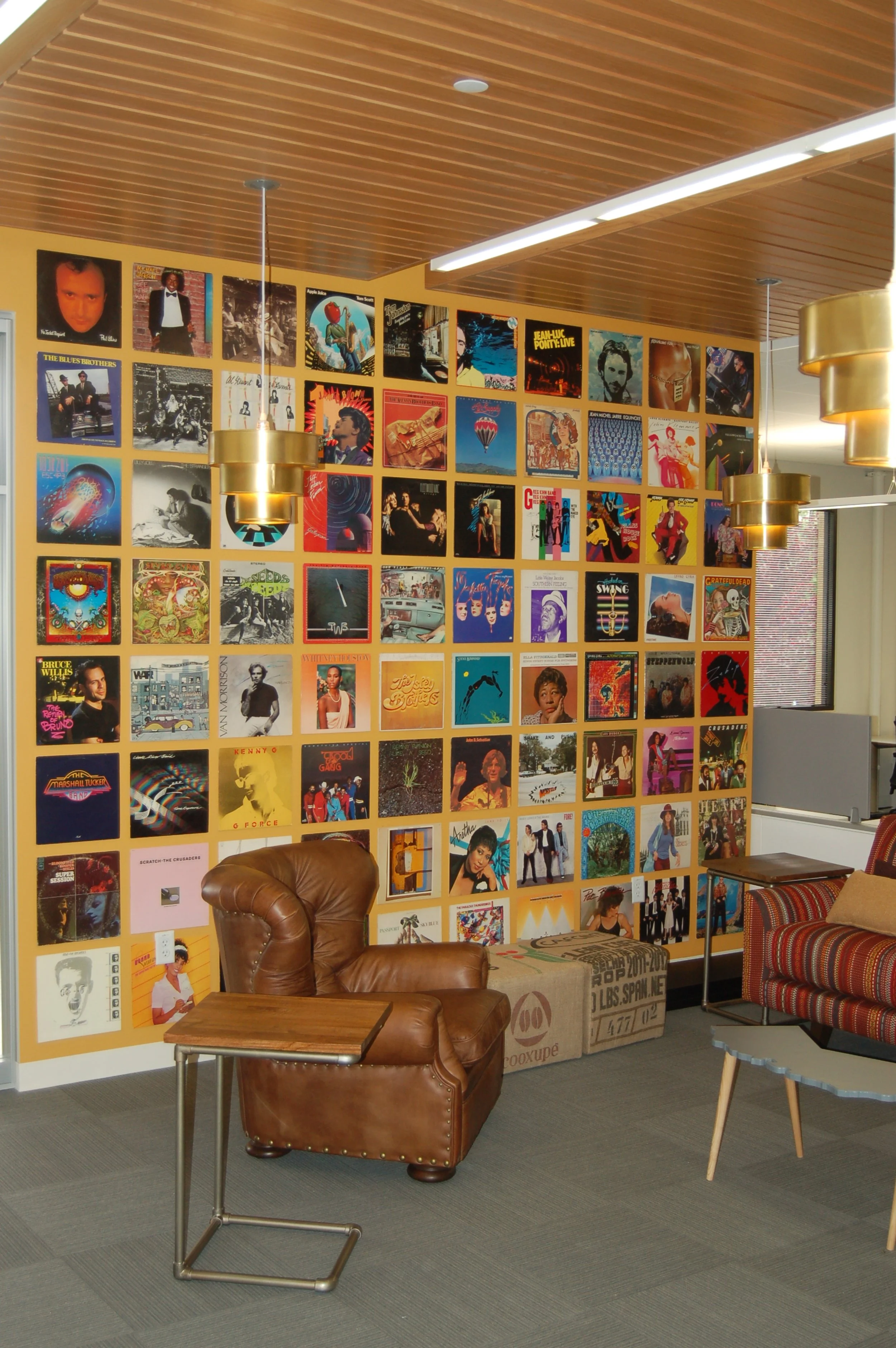 Large-scale gallery-style wall mural featuring multiple images for a creative office feature wall.