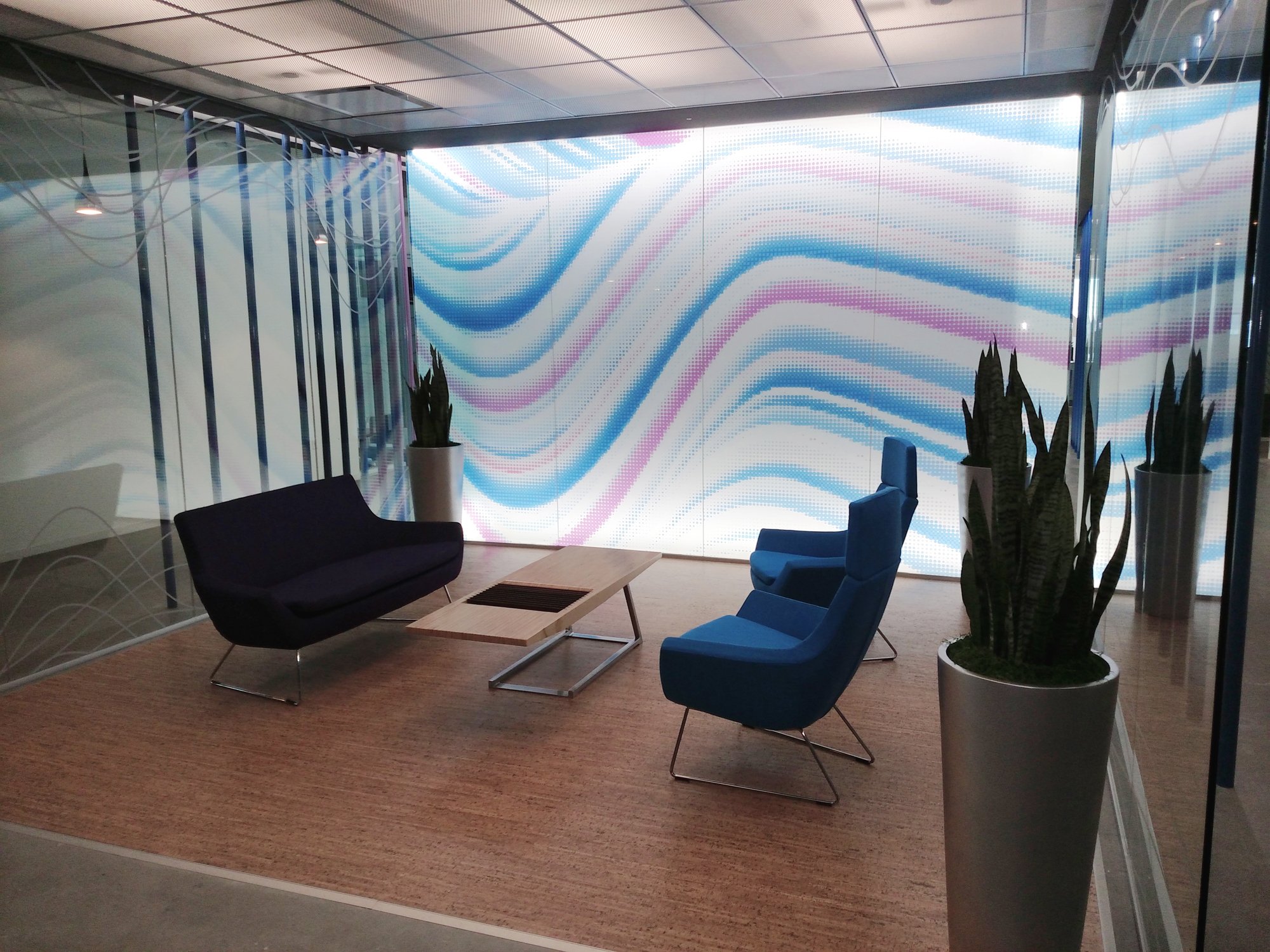 Full-wall digital print window film applied to office glass to add branding and visual impact to a workplace environment.