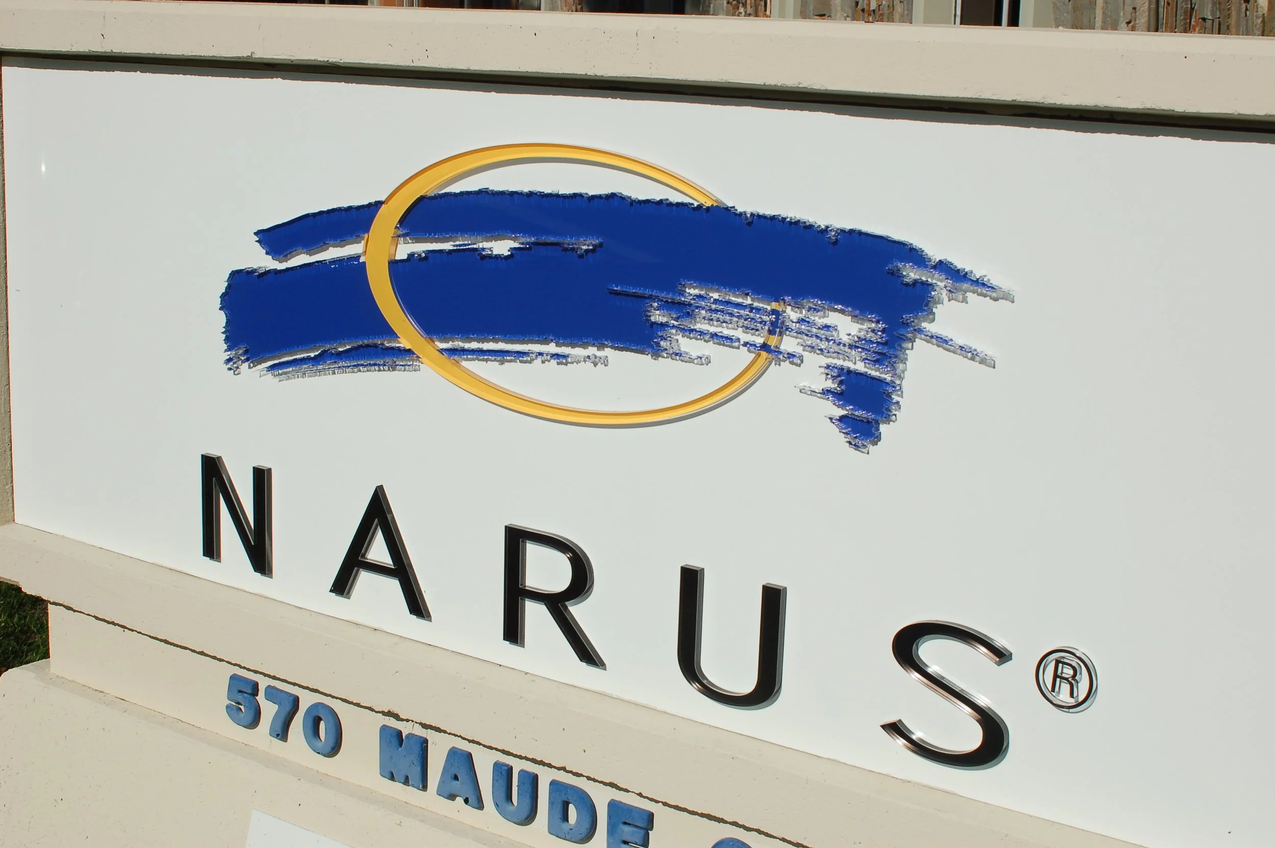 Custom exterior building signage installed for Narus to enhance corporate brand visibility