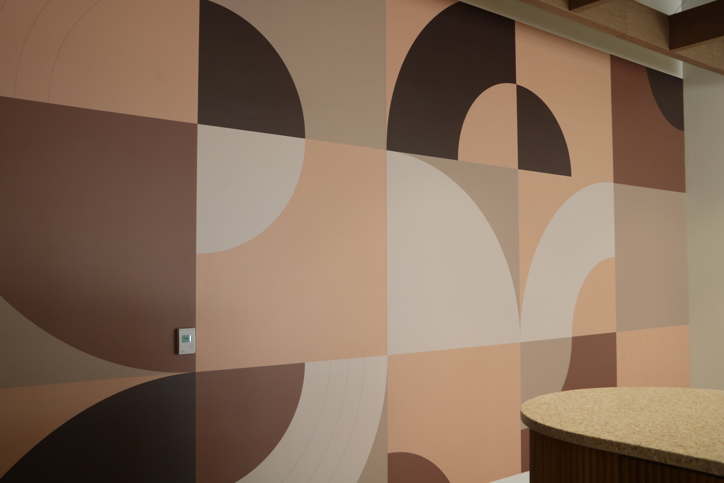 Installed decorative wallcovering enhancing the design and durability of a workplace breakroom kitchen.