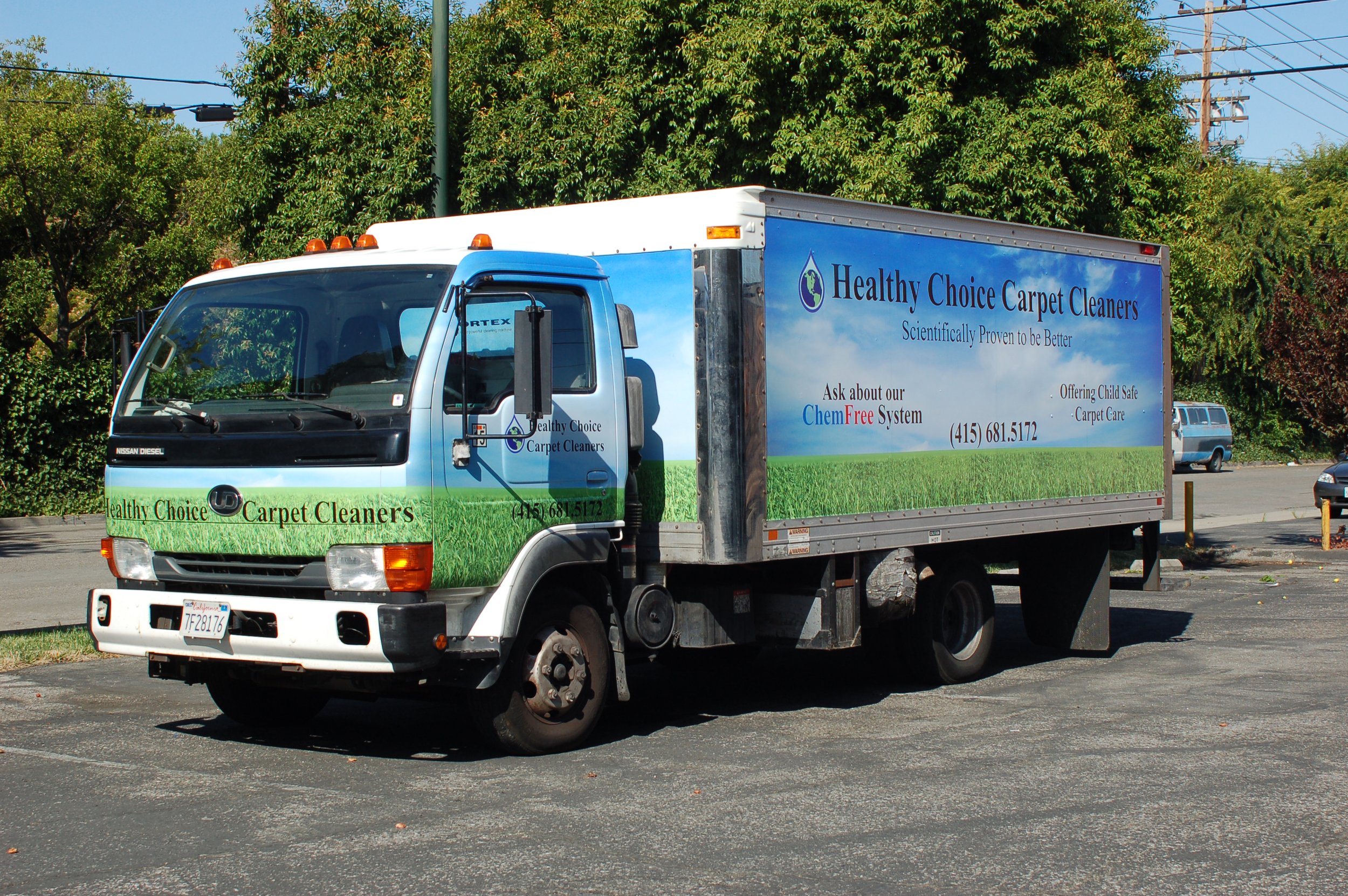 Commercial delivery truck wrap with large-format branding and promotional graphics