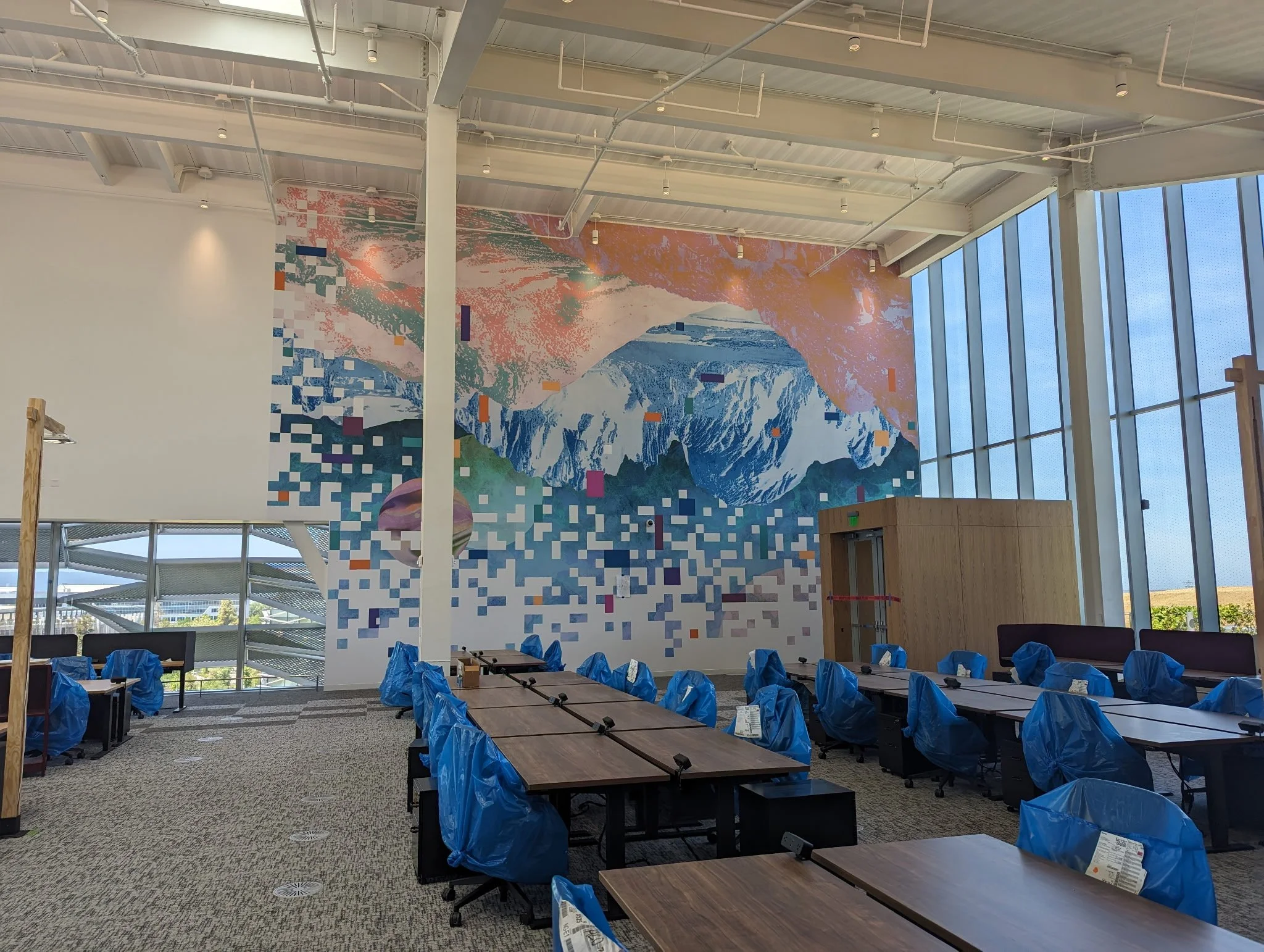 Custom environmental wall graphic installed in a conference room to support collaboration and brand identity.