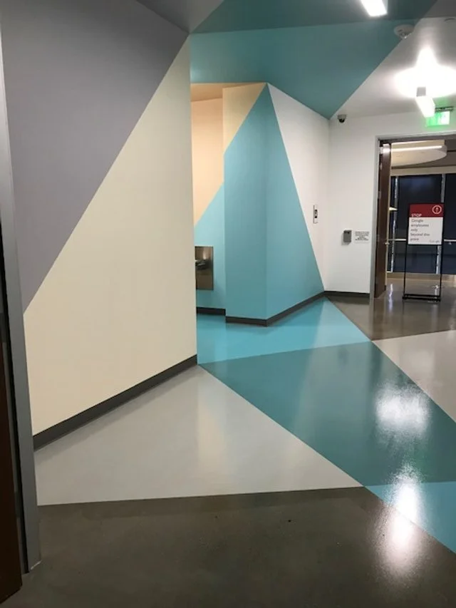 Custom commercial floor graphics defining pathways and circulation zones in office corridor