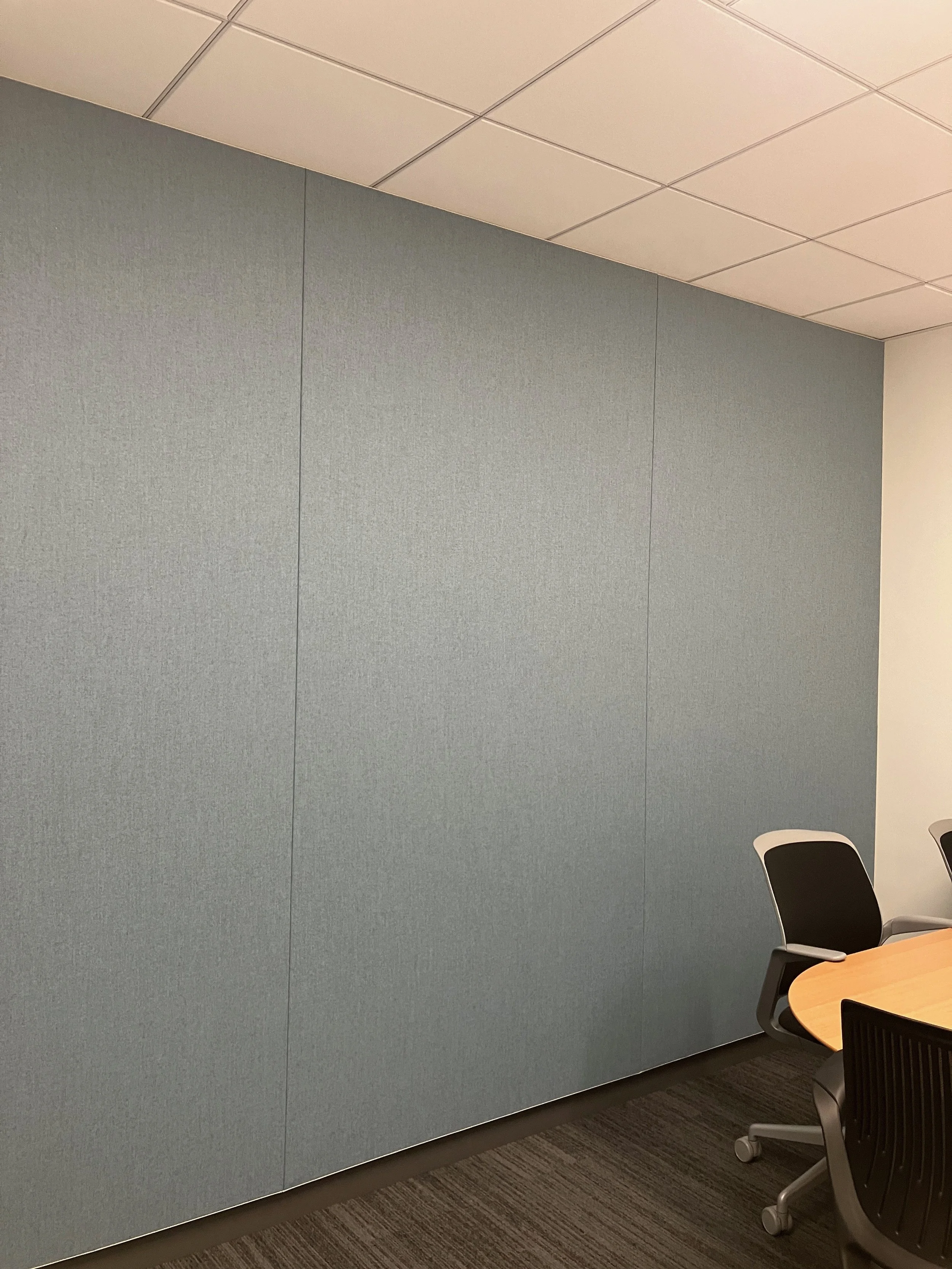Fabric acoustic wall installation reducing noise in open office environment