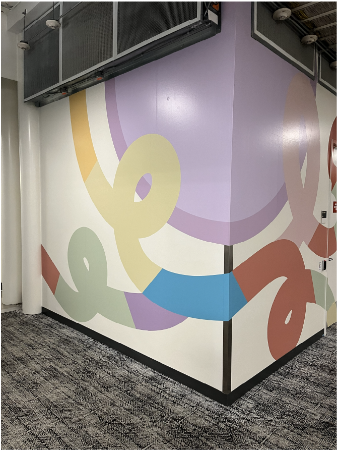 Custom environmental graphics wrapping a corner wall in the Amphitheatre interior.