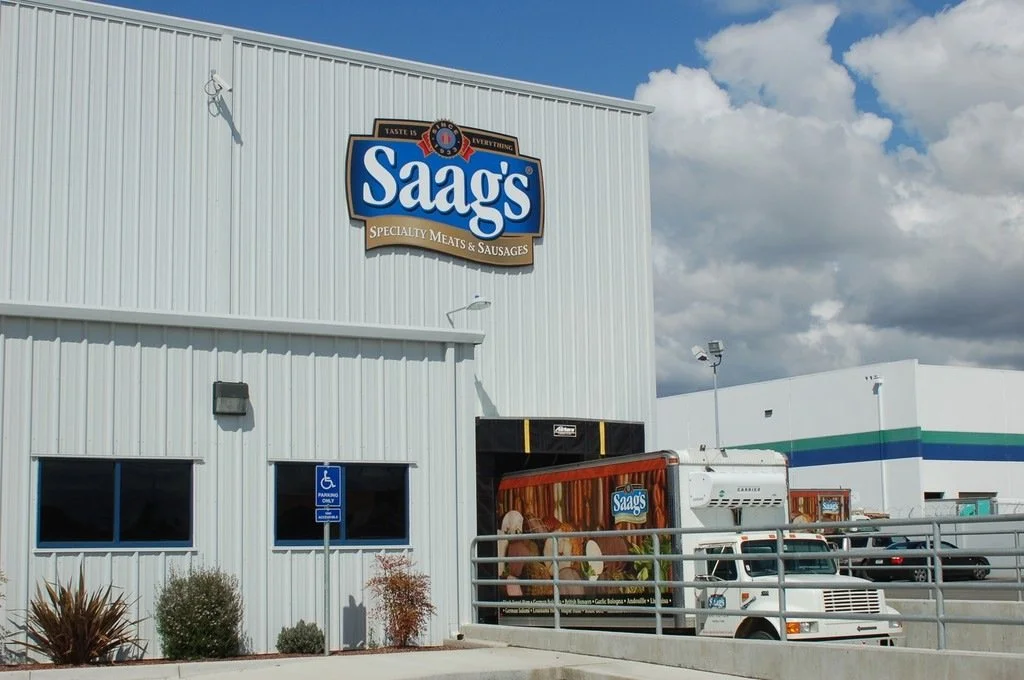 Exterior building signage for Saag's providing high-visibility retail storefront branding