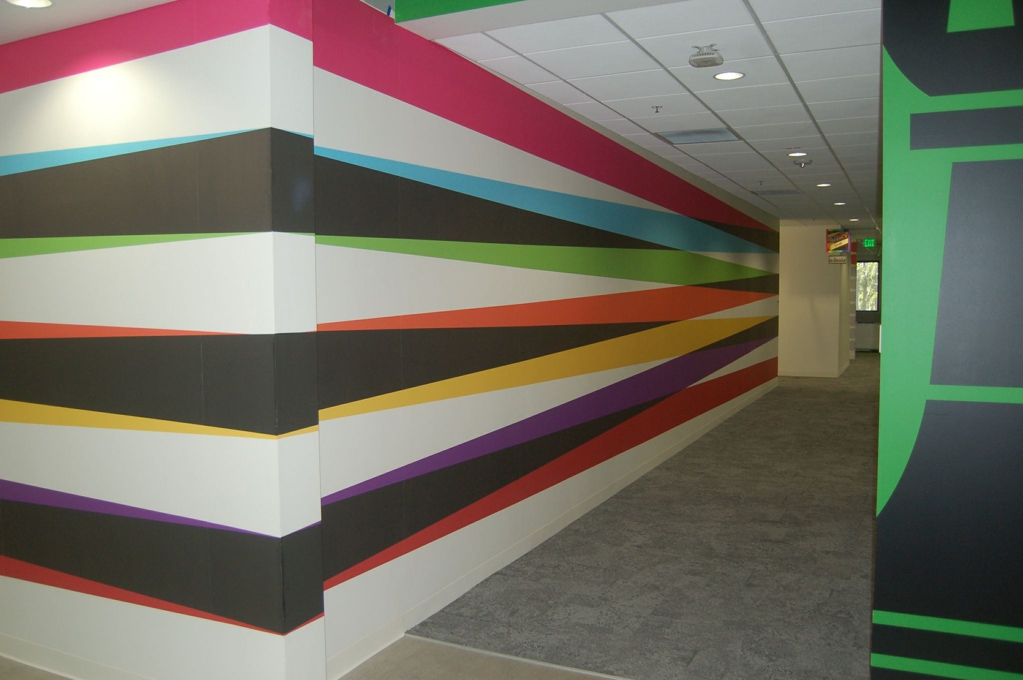 Color band feature wall graphic adding bold visual impact to a commercial corridor.