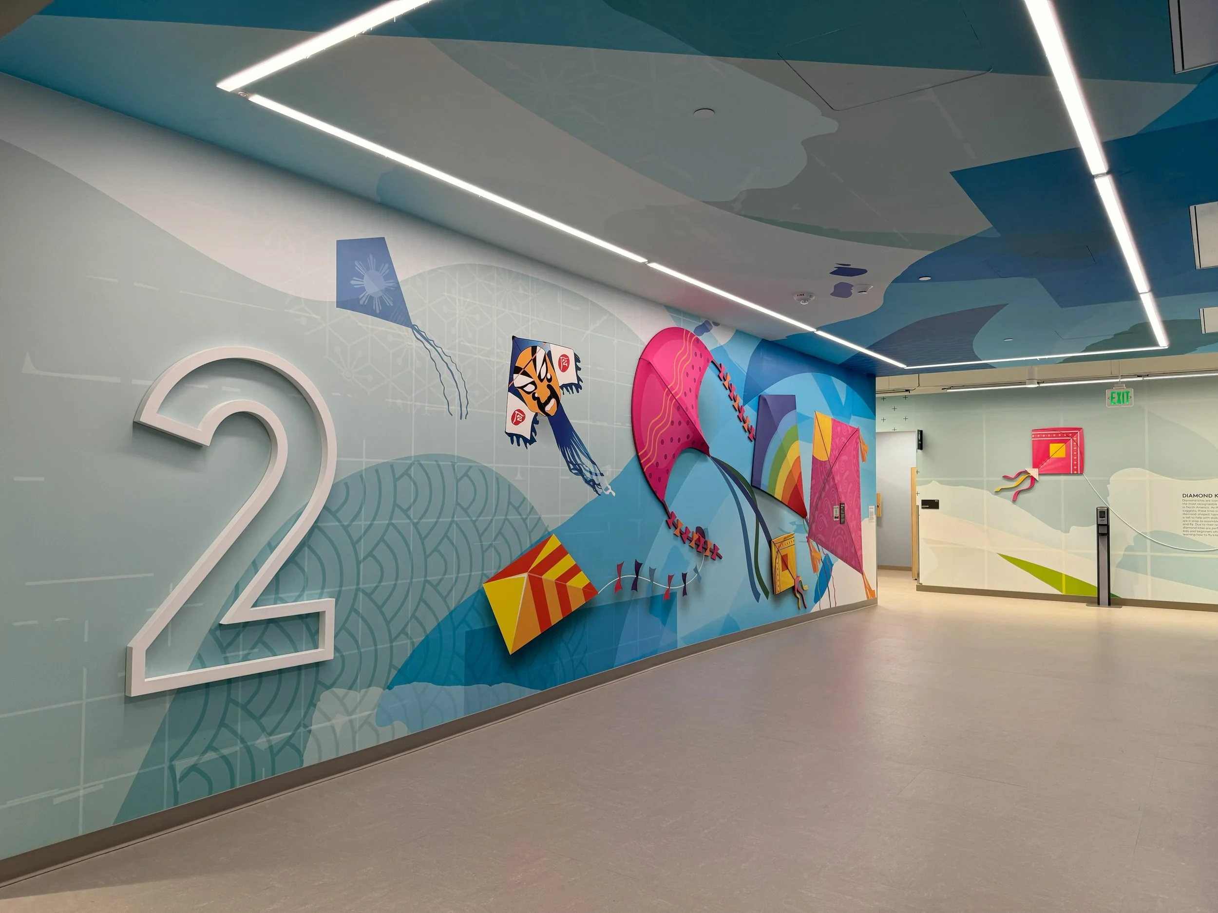 Colorful large-format wall mural installed in corporate office hallway as custom environmental graphics.