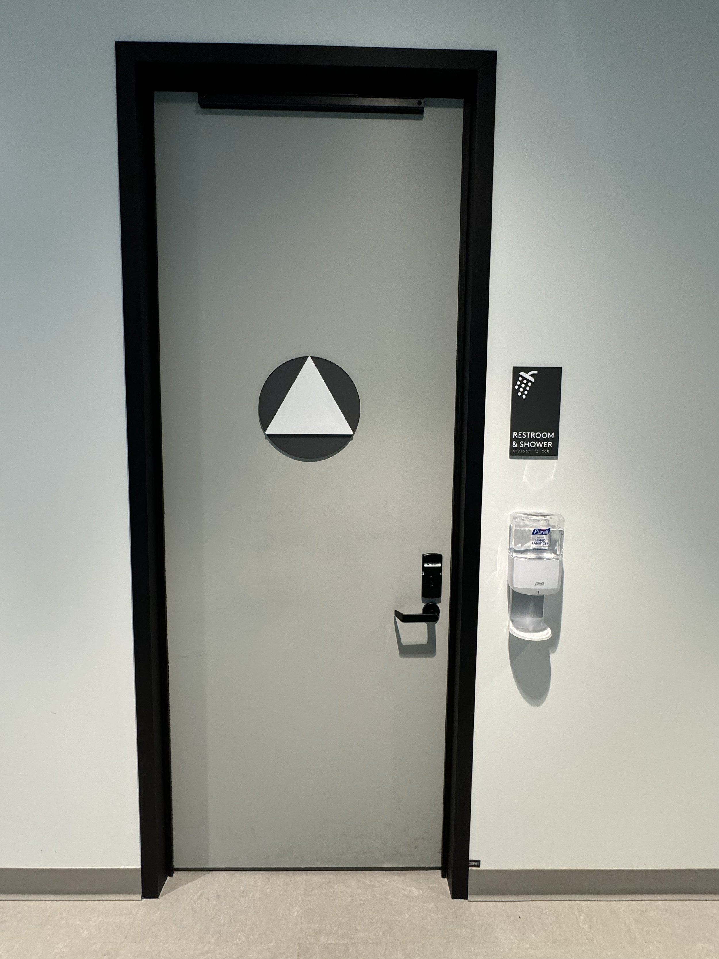 Minimalist door identification and ADA-compliant hardware supporting accessible interior navigation.