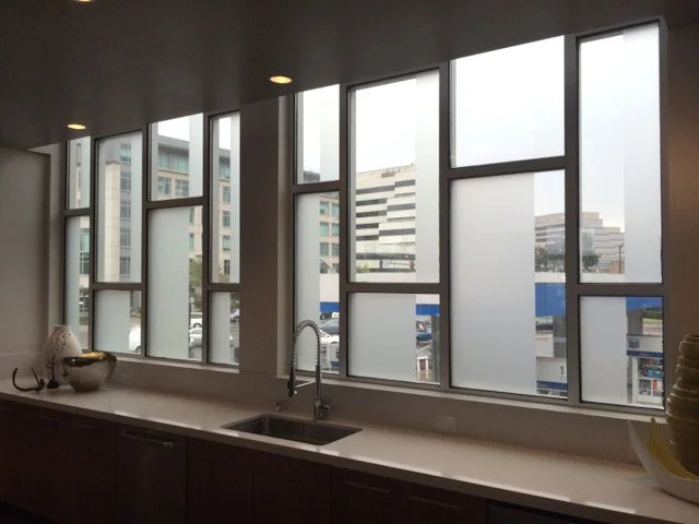 Frosted privacy window film applied to office windows for daylight control and visual privacy