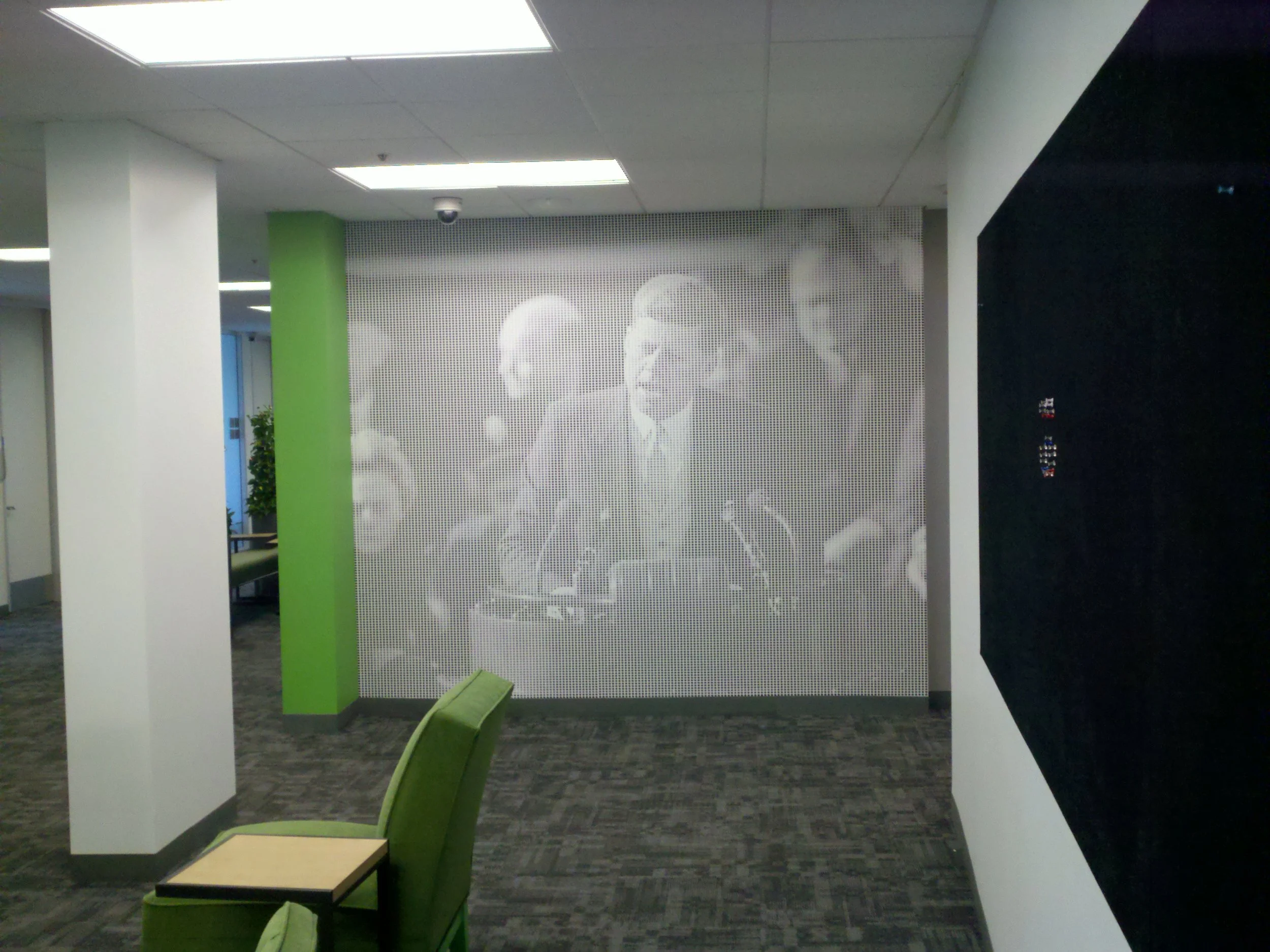 Patterned commercial wallcovering adding texture and visual interest to a corporate hallway.