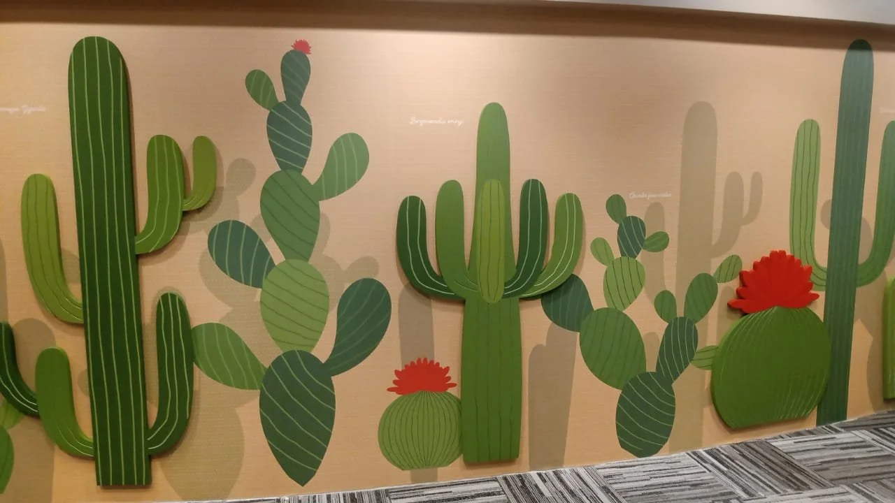 Close-up of custom cactus wallcovering with layered dimensional Sintra elements installed at Amazon SJC3 in Cupertino, California by JP Digital.