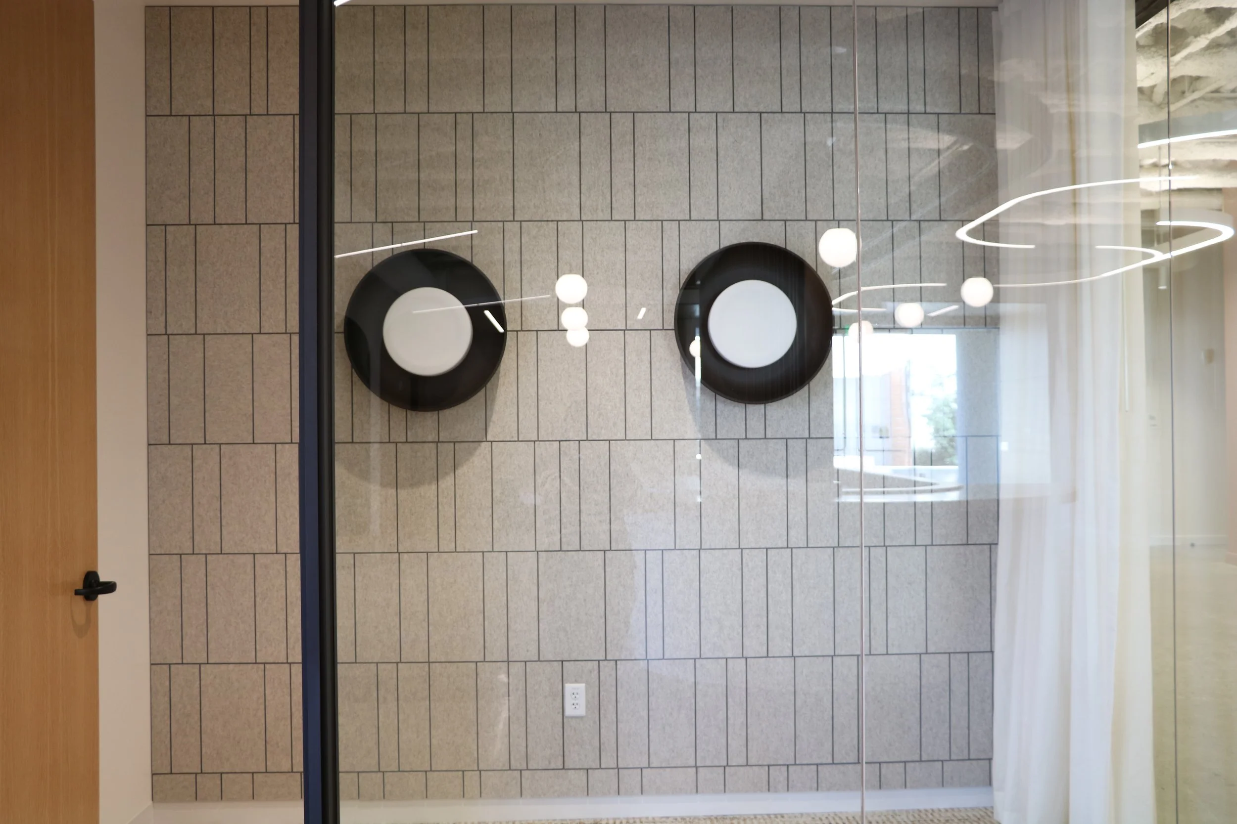 Acoufelt Fracture Barcode acoustic wall panels in Quartz installed in private office with glass partition for enhanced workplace sound control.