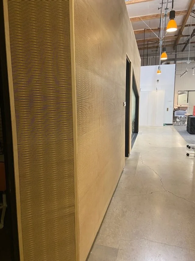 Textured dimensional wood wall panel detail for modern commercial interior design