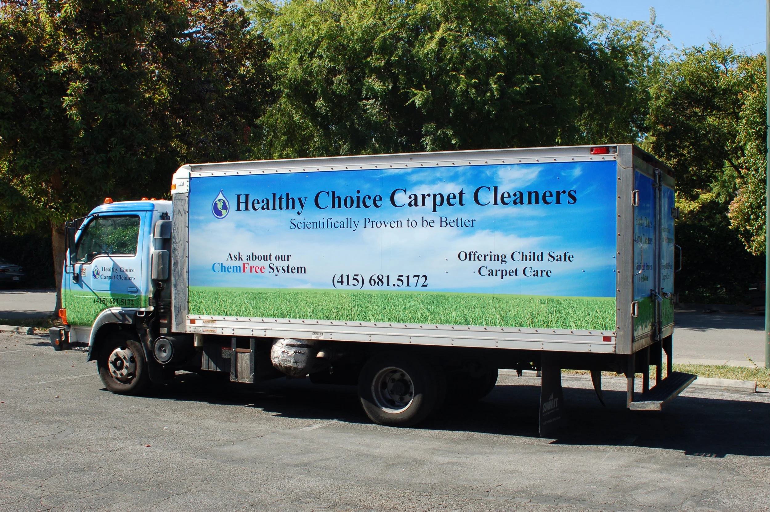 Custom box truck wrap featuring scenic graphics and corporate branding