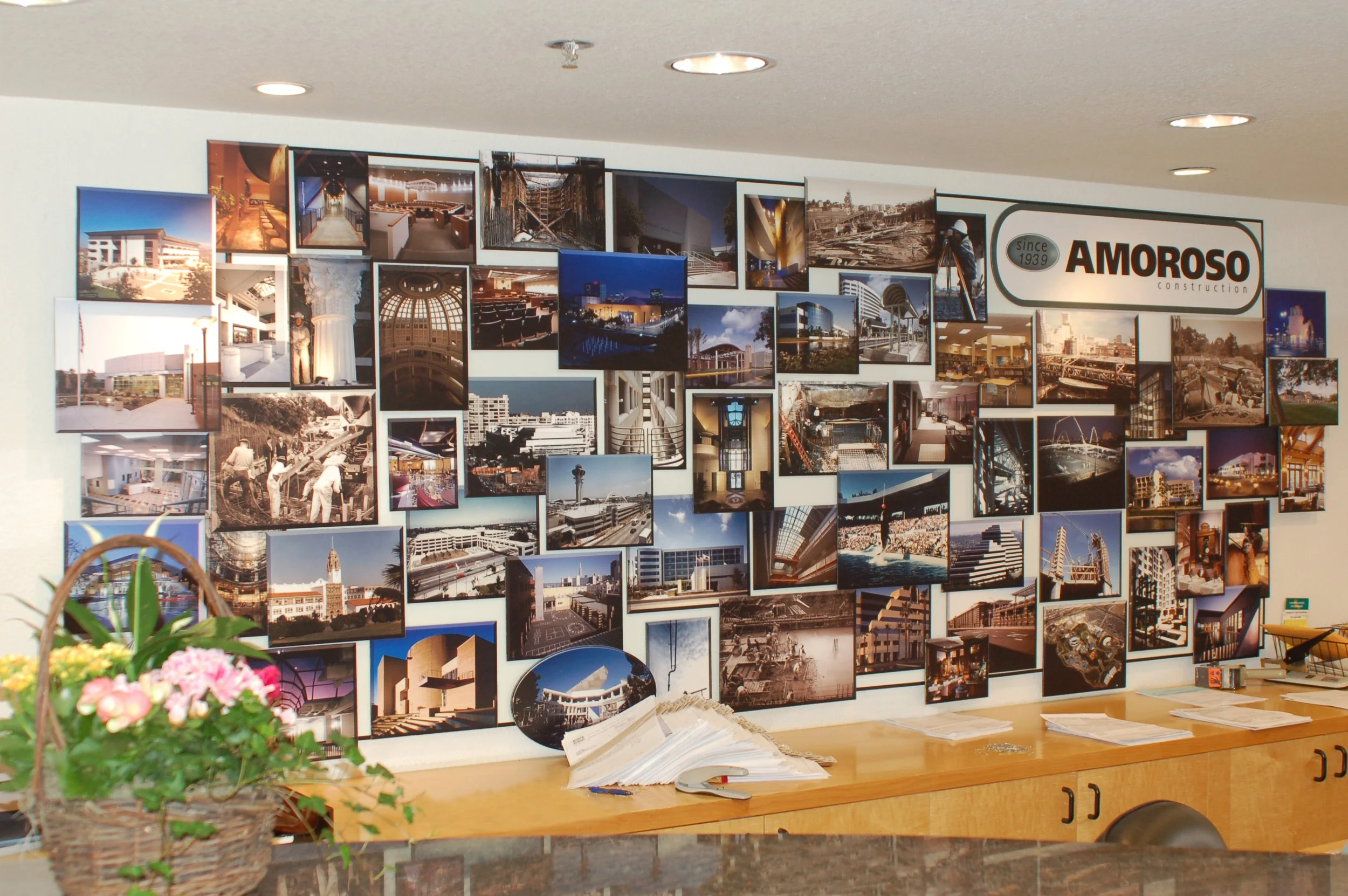 Custom branded photo display wall installed to enhance workplace storytelling and strengthen company brand presence