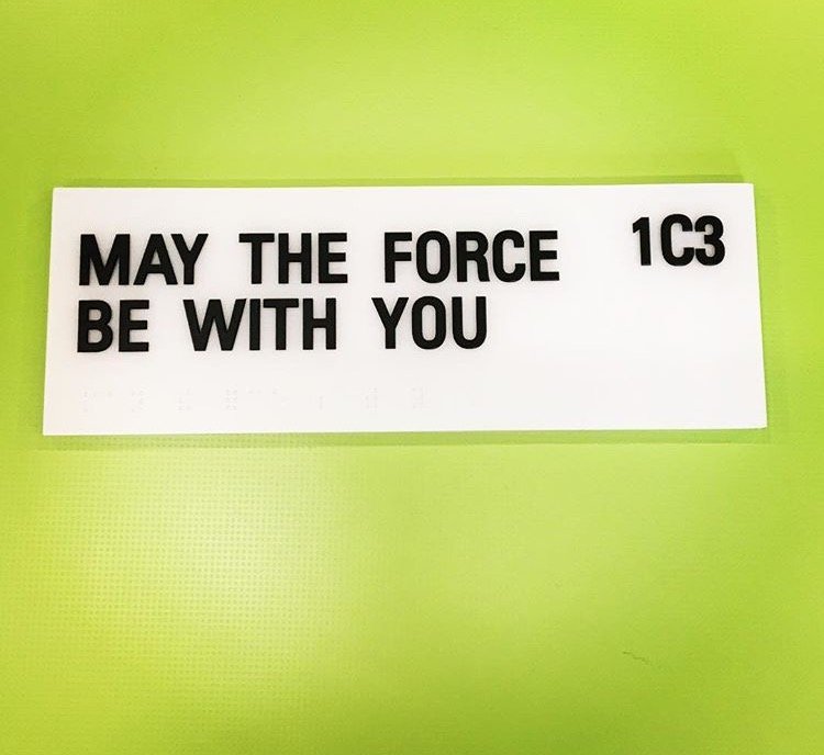 Custom room identification signage designed to enhance navigation and add personality to workplace interior