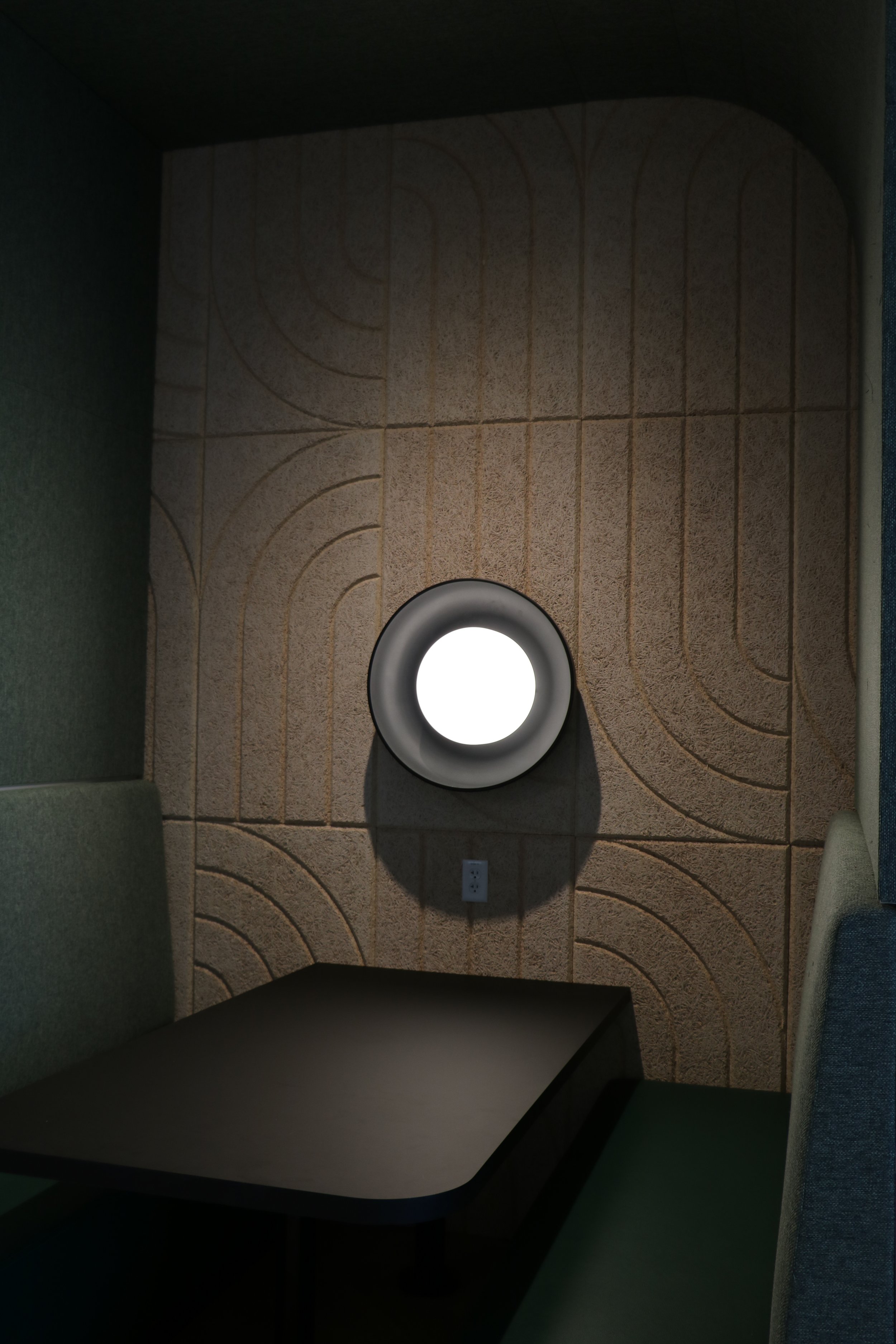 Close-up of BAUX Wood Wool Curve acoustic panels with geometric pattern installed on feature wall in corporate interior.