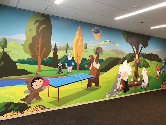 Large-scale community illustration mural designed to enhance a welcoming corporate environment.