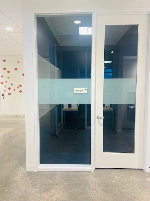 Strip window film providing conference room privacy while maintaining a clean, modern look.
