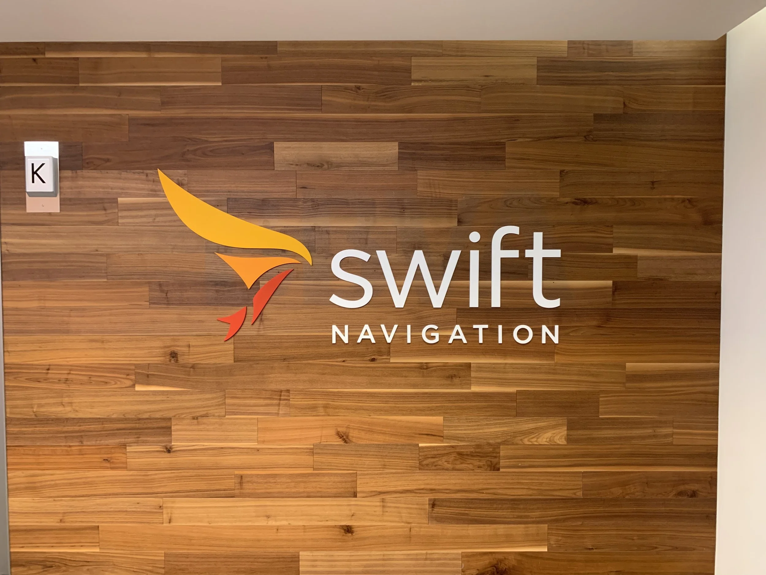 Dimensional Swift Navigation logo signage installed to create a professional branded reception area
