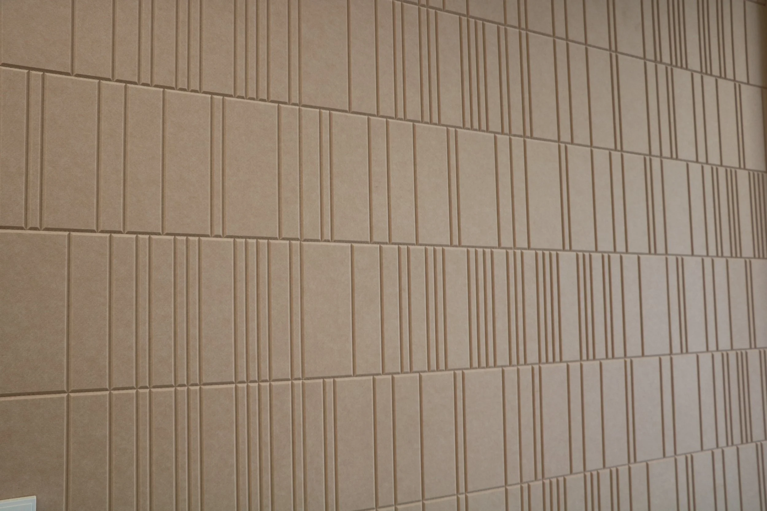 Close-up of Acoufelt Fracture Barcode Quartz PET acoustic panels showing linear texture and custom pattern for commercial interior sound control.