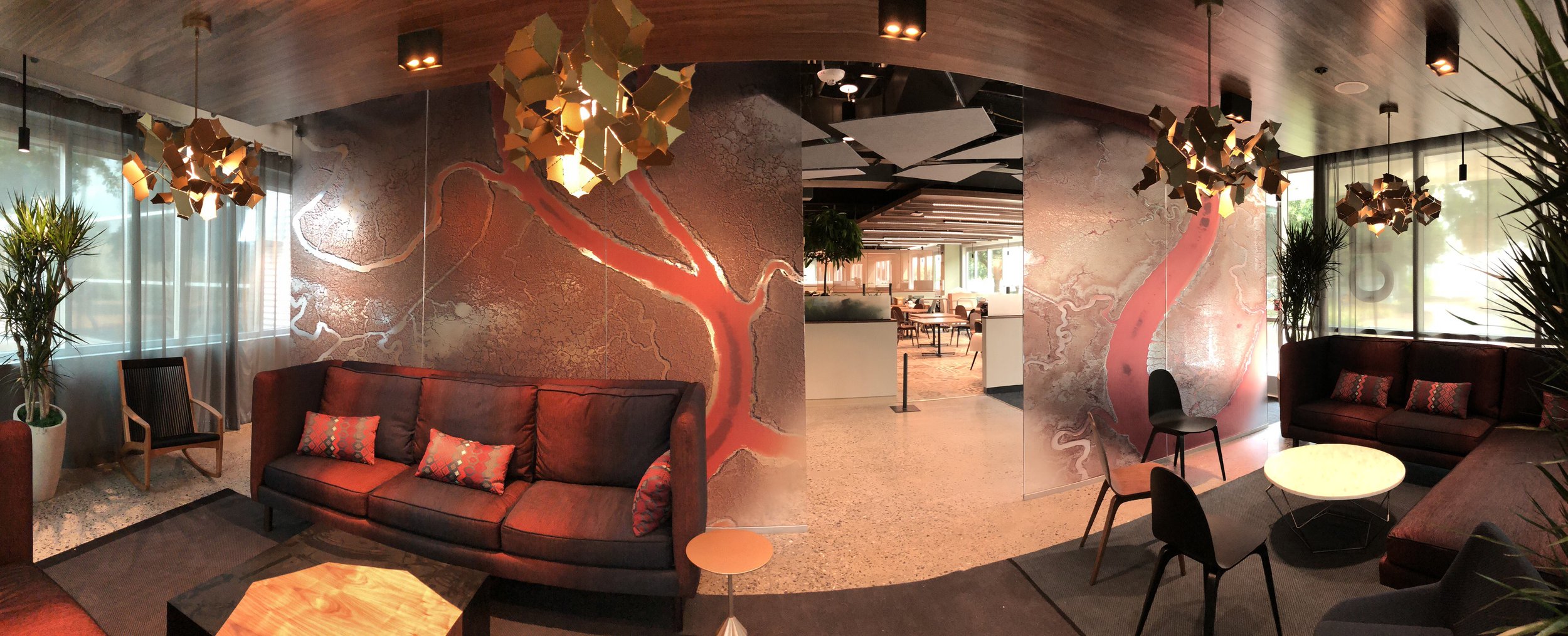 Decorative privacy window film with custom graphics applied to glass walls in a modern commercial office lobby.