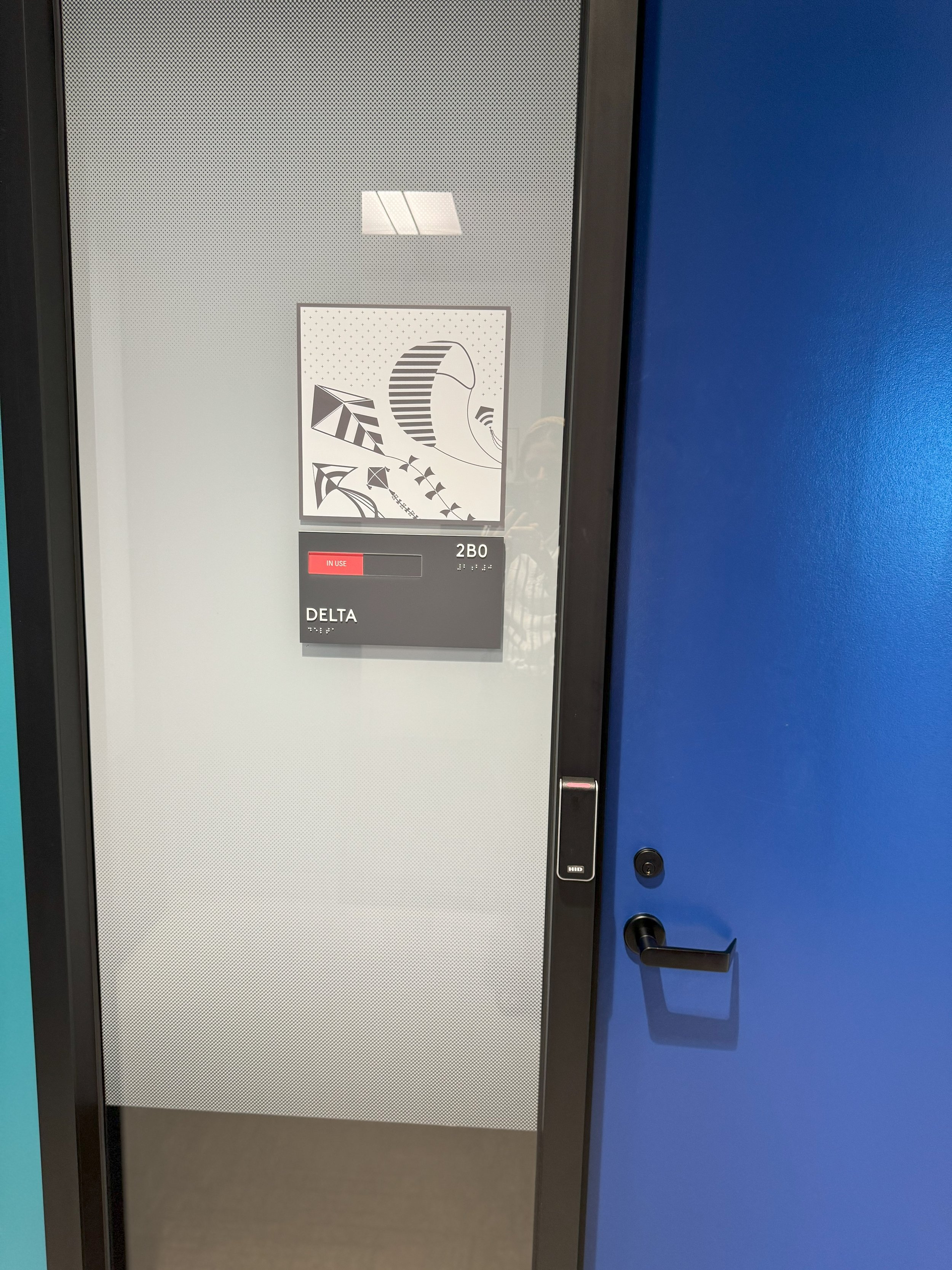 High-contrast room signage designed for accessibility and consistent wayfinding across the workplace.