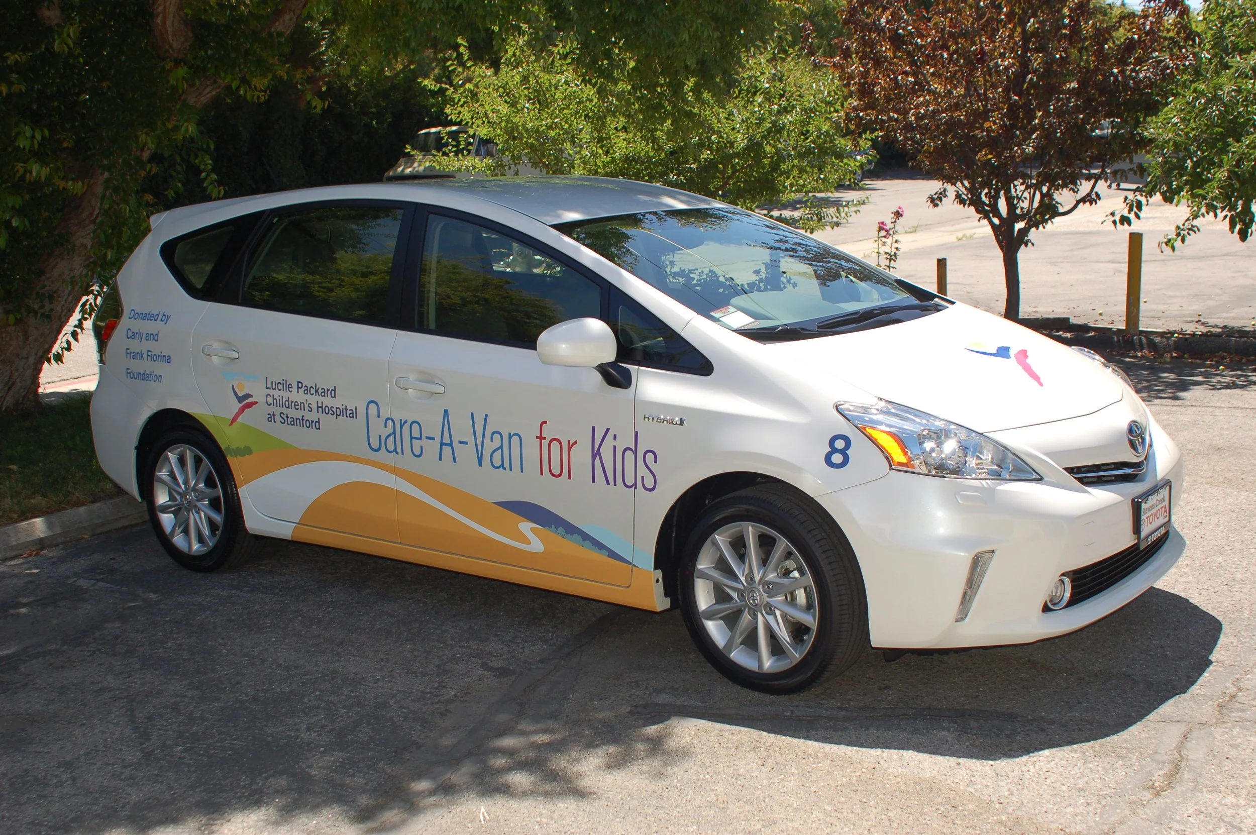 Hybrid service car with partial vehicle wrap and company branding used for field technicians and local service calls.