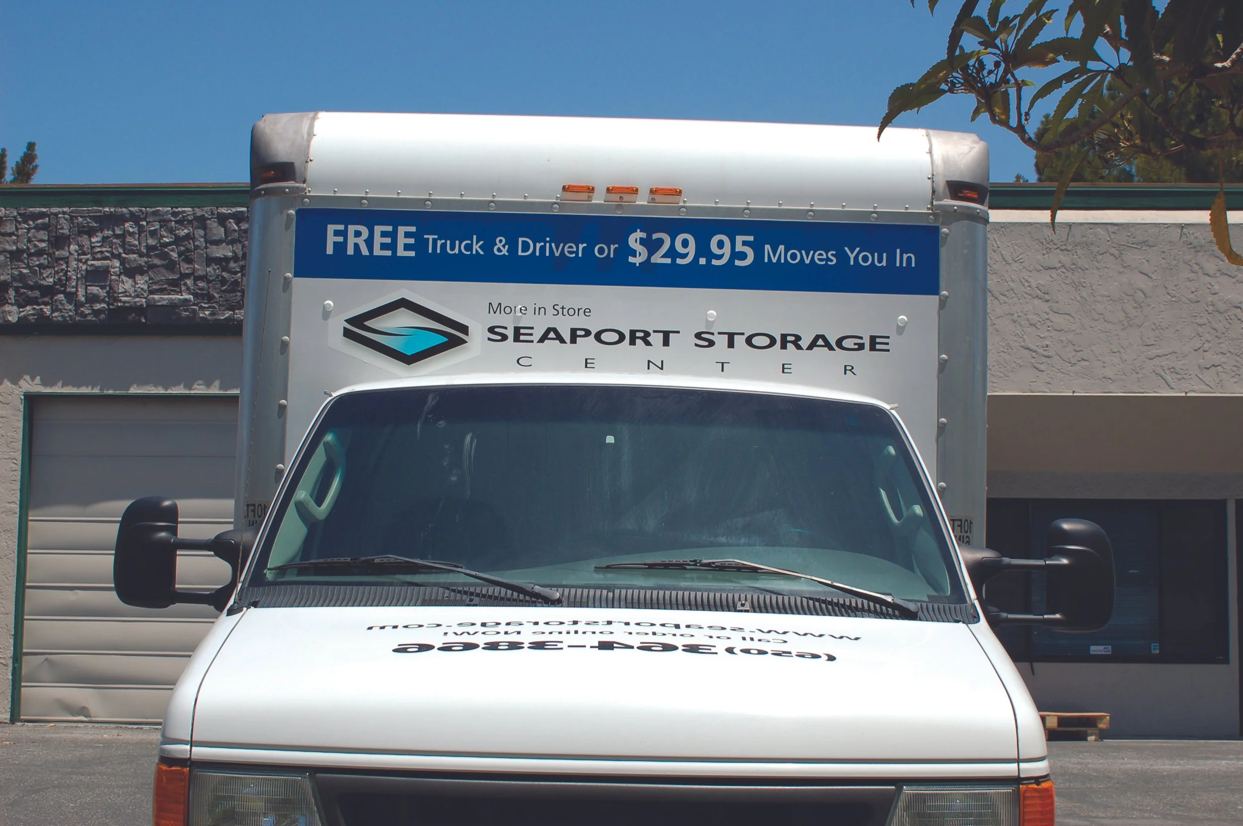 Commercial delivery truck with windshield and hood graphics for enhanced brand visibility during daily routes.