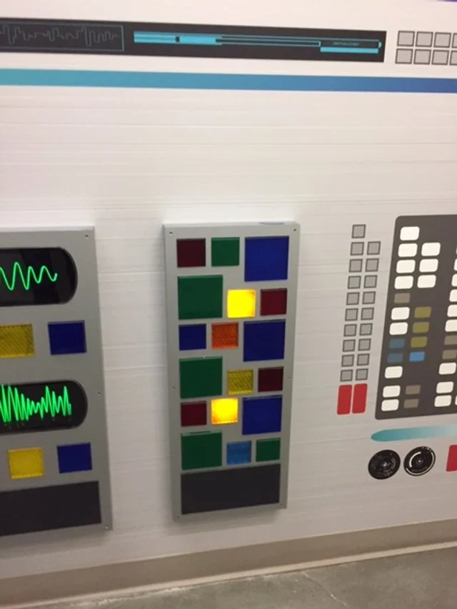 Dimensional environmental graphics inspired by control systems, combining color, texture, and layered fabrication.