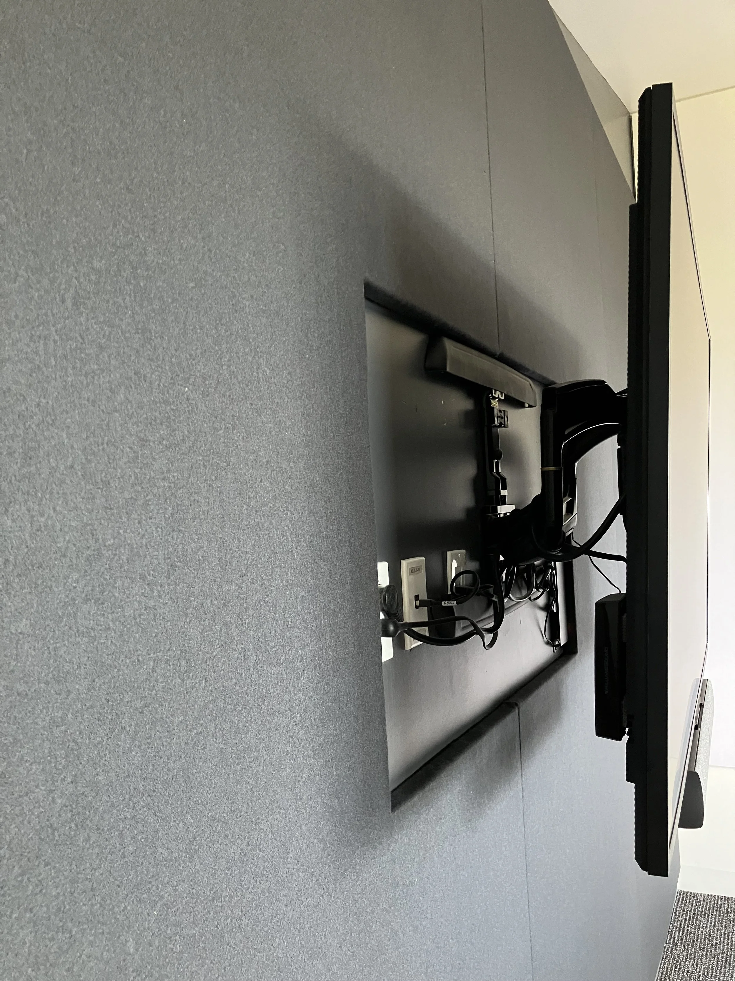 Full-height fabric acoustic wall providing large-scale sound absorption in workplace interior