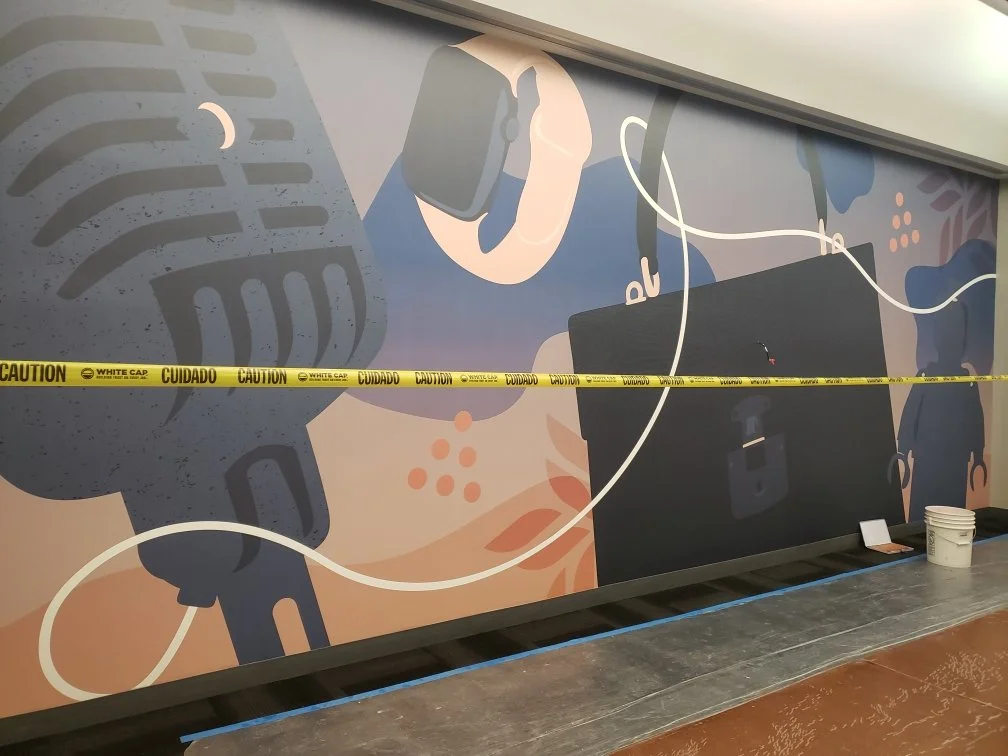 eBay Austin elevator lobby wallcovering installation featuring large-format custom graphics with instrument-inspired artwork and environmental branding.