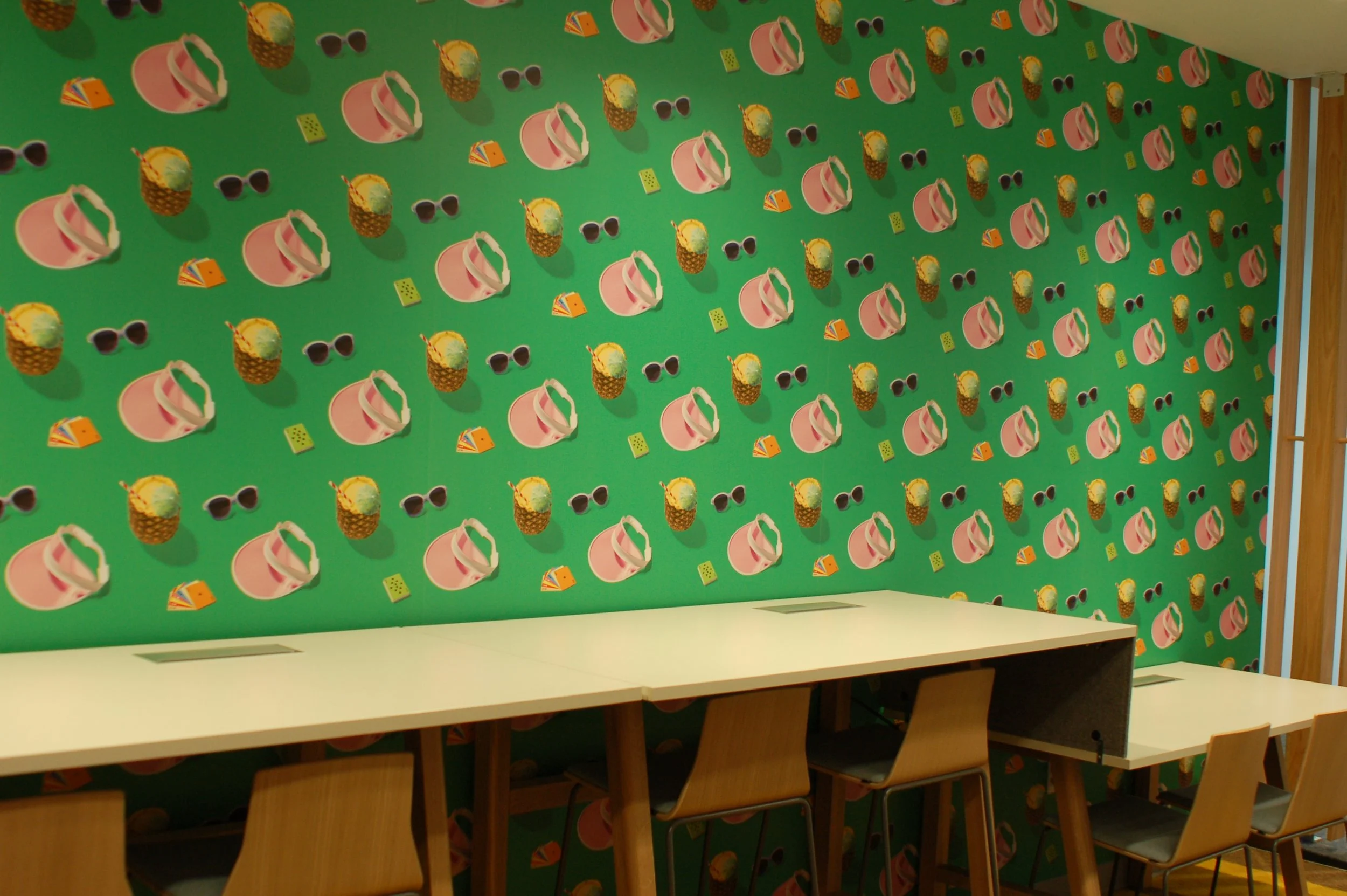 Playful illustrated wallcovering installed in a creative workspace as a custom environmental graphic.