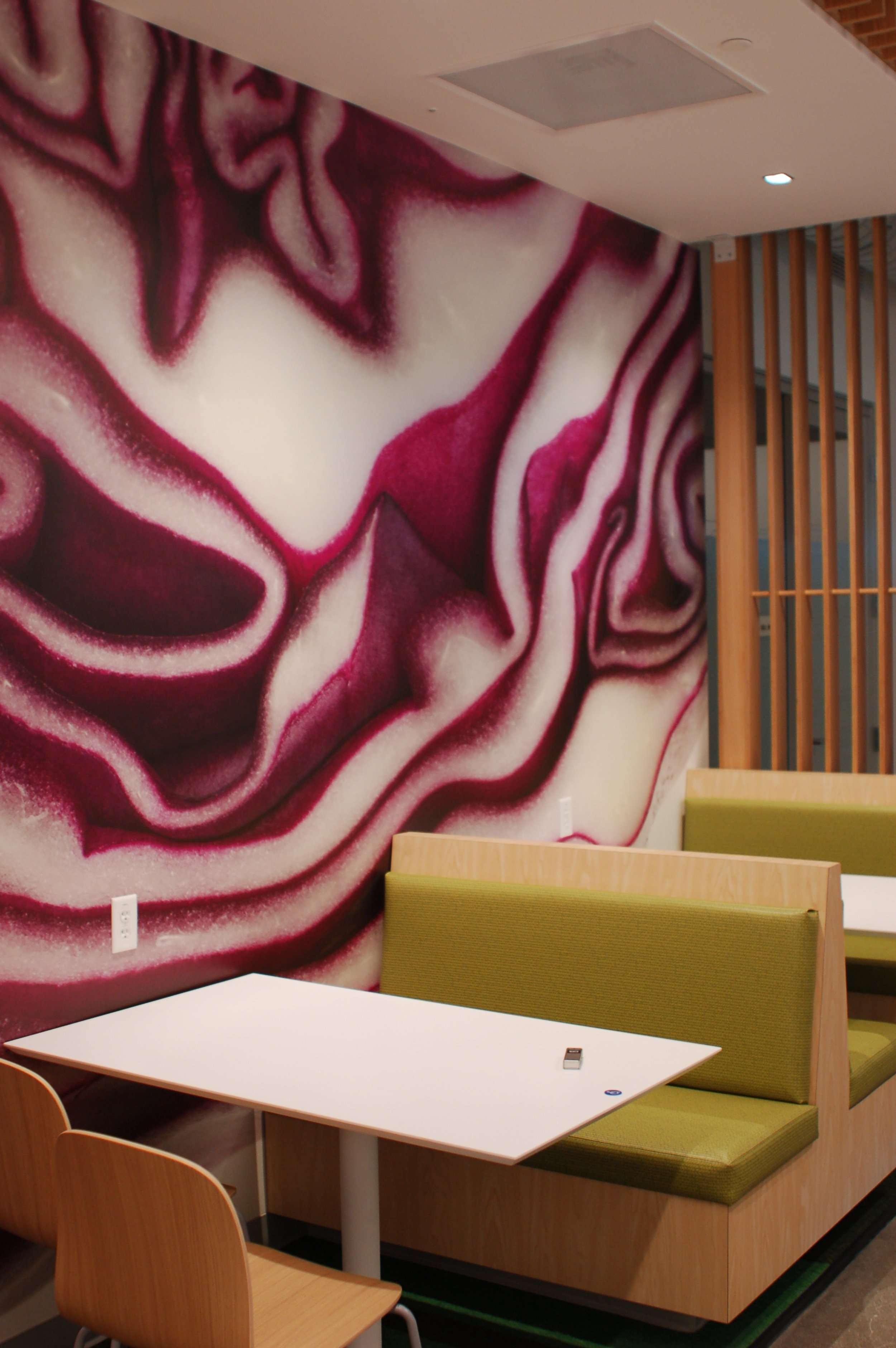 Abstract marble-pattern wallcovering creating a modern decorative feature wall in a corporate workspace.