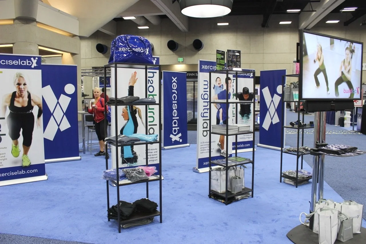 Custom modular trade show display with branded graphics, banner stands, and product shelving designed for portable, high-impact event marketing and brand visibility.
