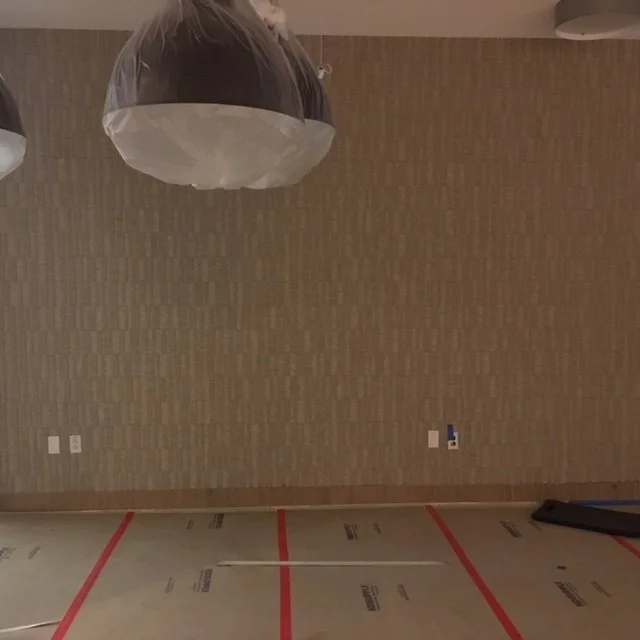 Vertical wood slat acoustic wall adding texture and improving sound quality in office space