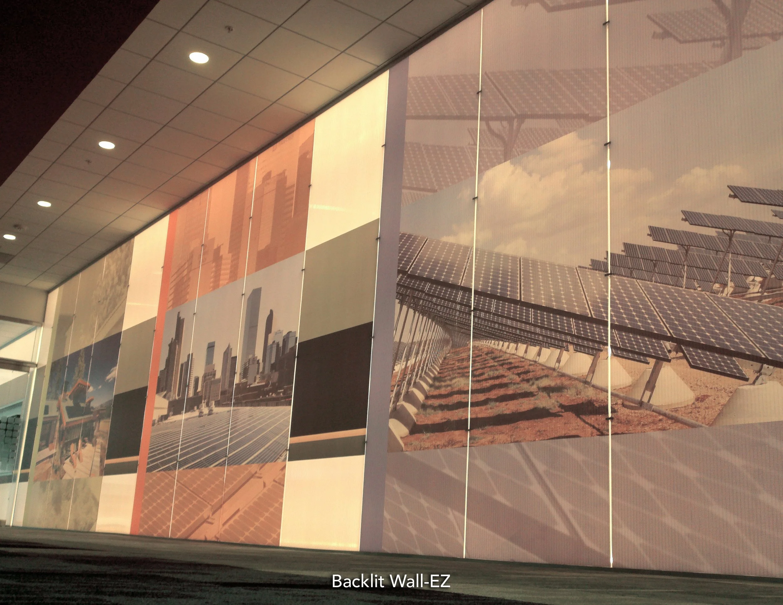 Large-format cityscape wallcovering installed in a corporate office to create a branded feature wall.