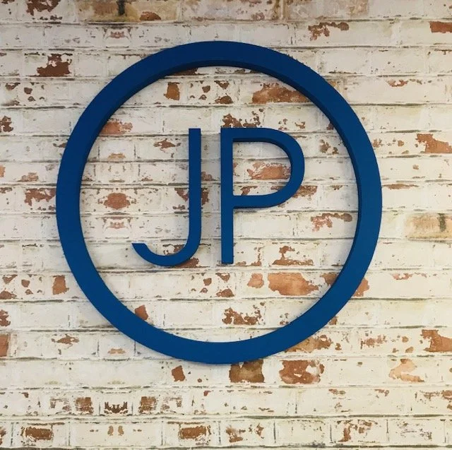 Dimensional JP Digital logo signage installed on feature wall to create a branded lobby environment