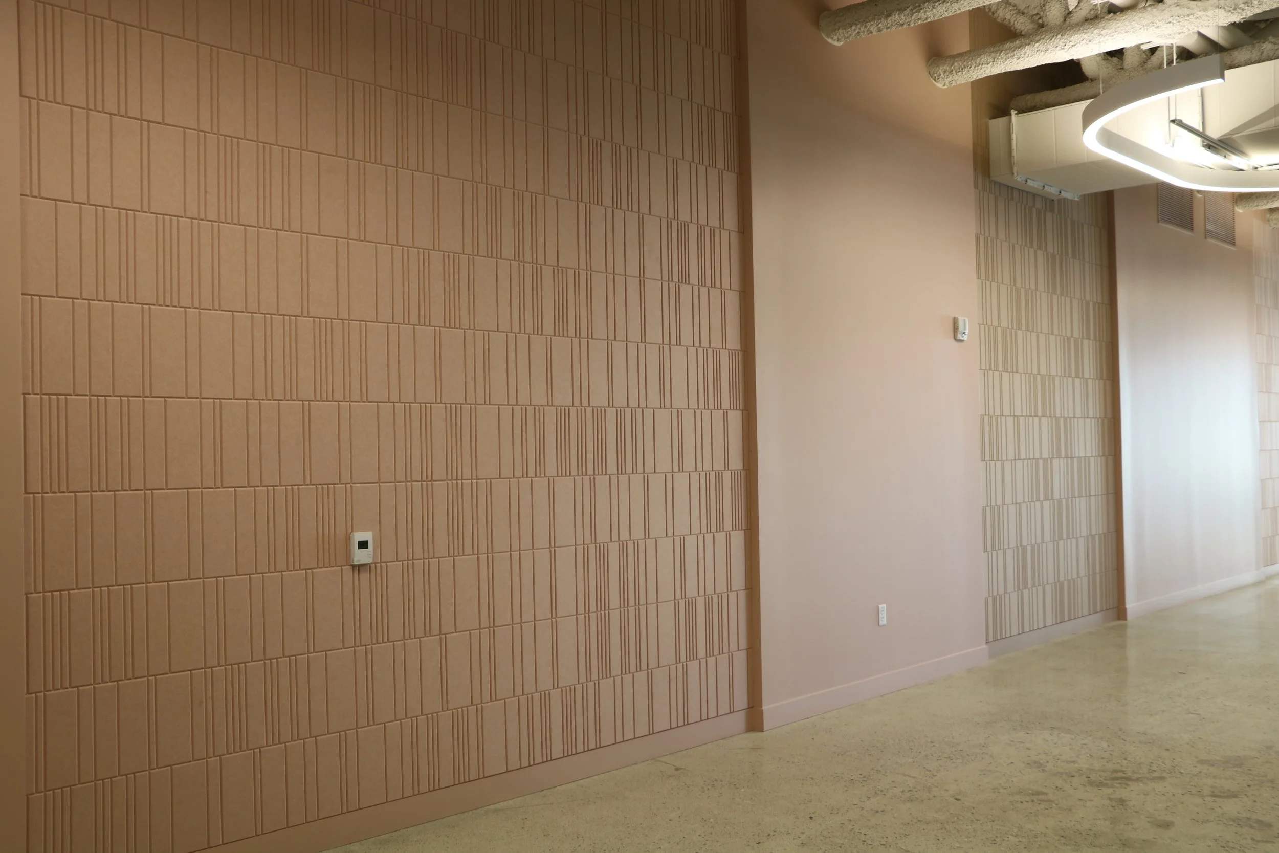Acoufelt Fracture Barcode acoustic wall panels in Quartz installed along commercial office corridor for sound absorption and architectural design.